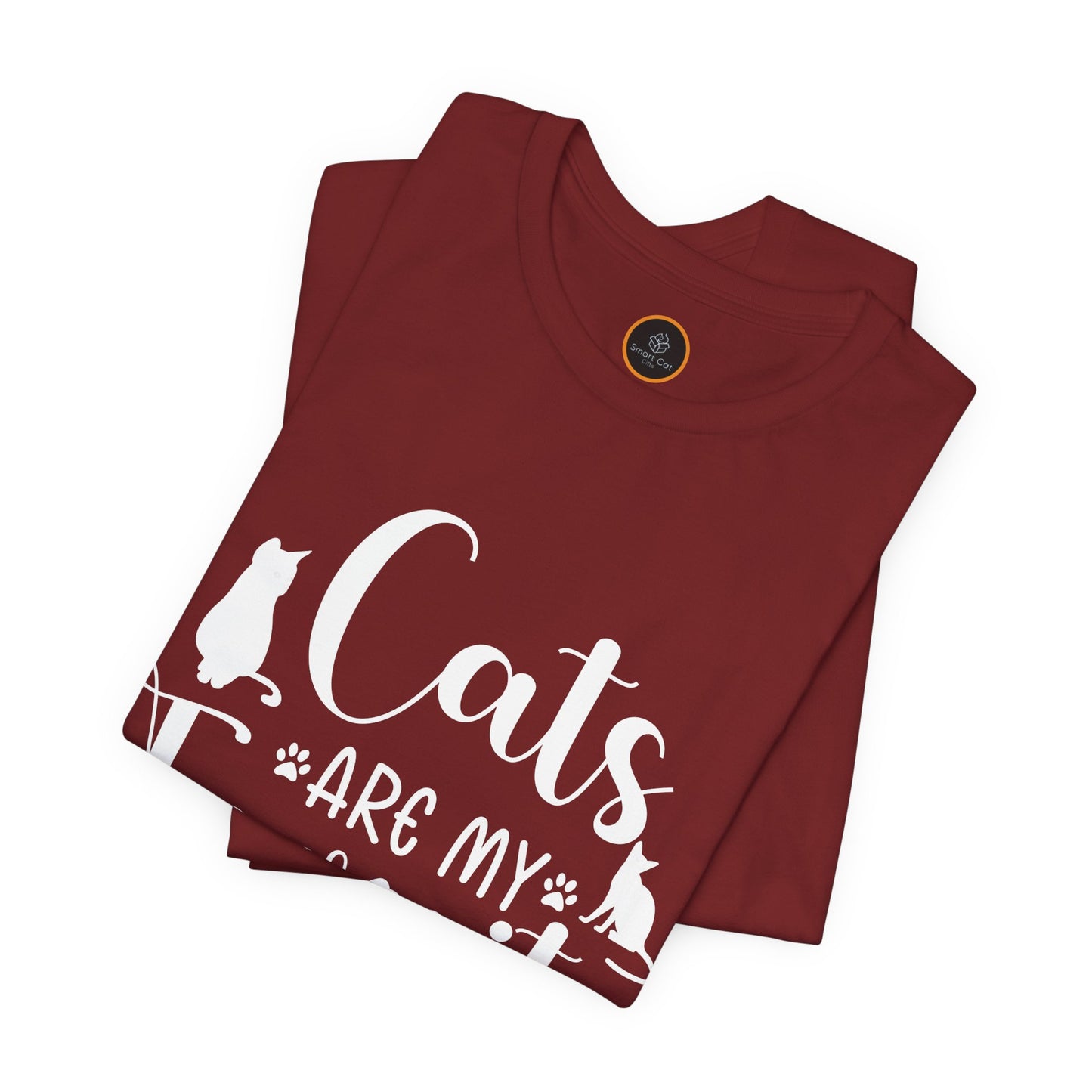 A folded t-shirt with the text "Cats are my favorite people" in large letters, complemented by a design of four cat paw prints and two cat silhouettes.