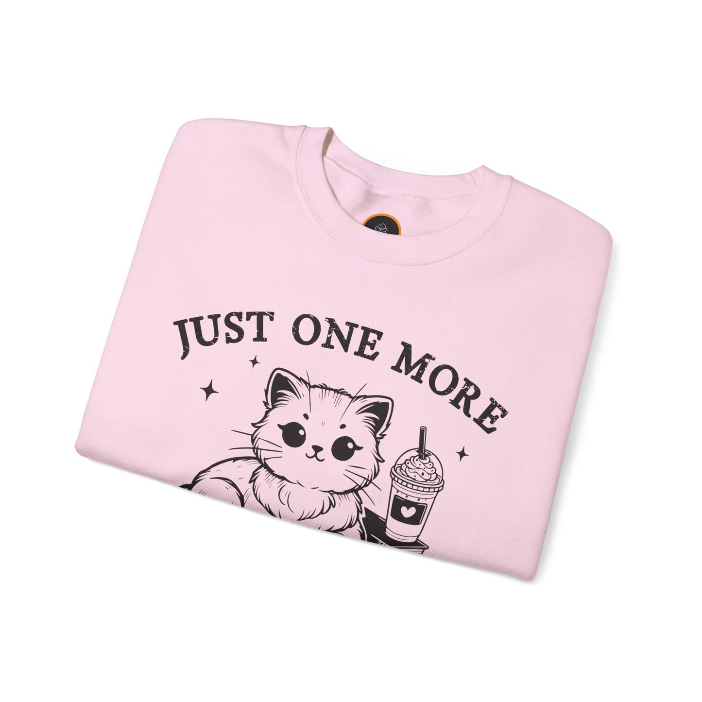 Just One More Chapter" light gray crewneck sweatshirt with a graphic of a cat reading a book next to a Frappuccino on a stack of books.