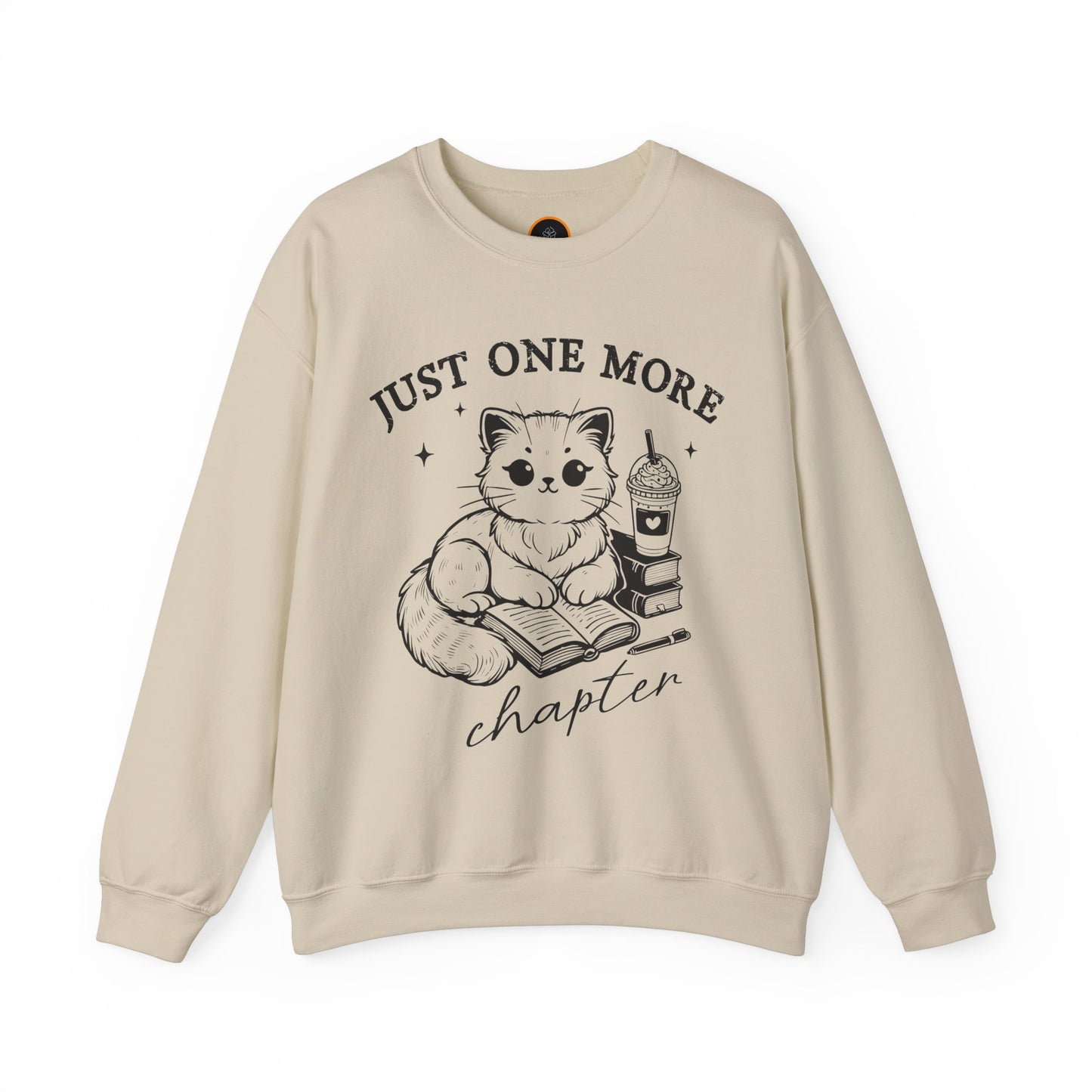 Just One More Chapter" light gray crewneck sweatshirt with a graphic of a cat reading a book next to a Frappuccino on a stack of books.