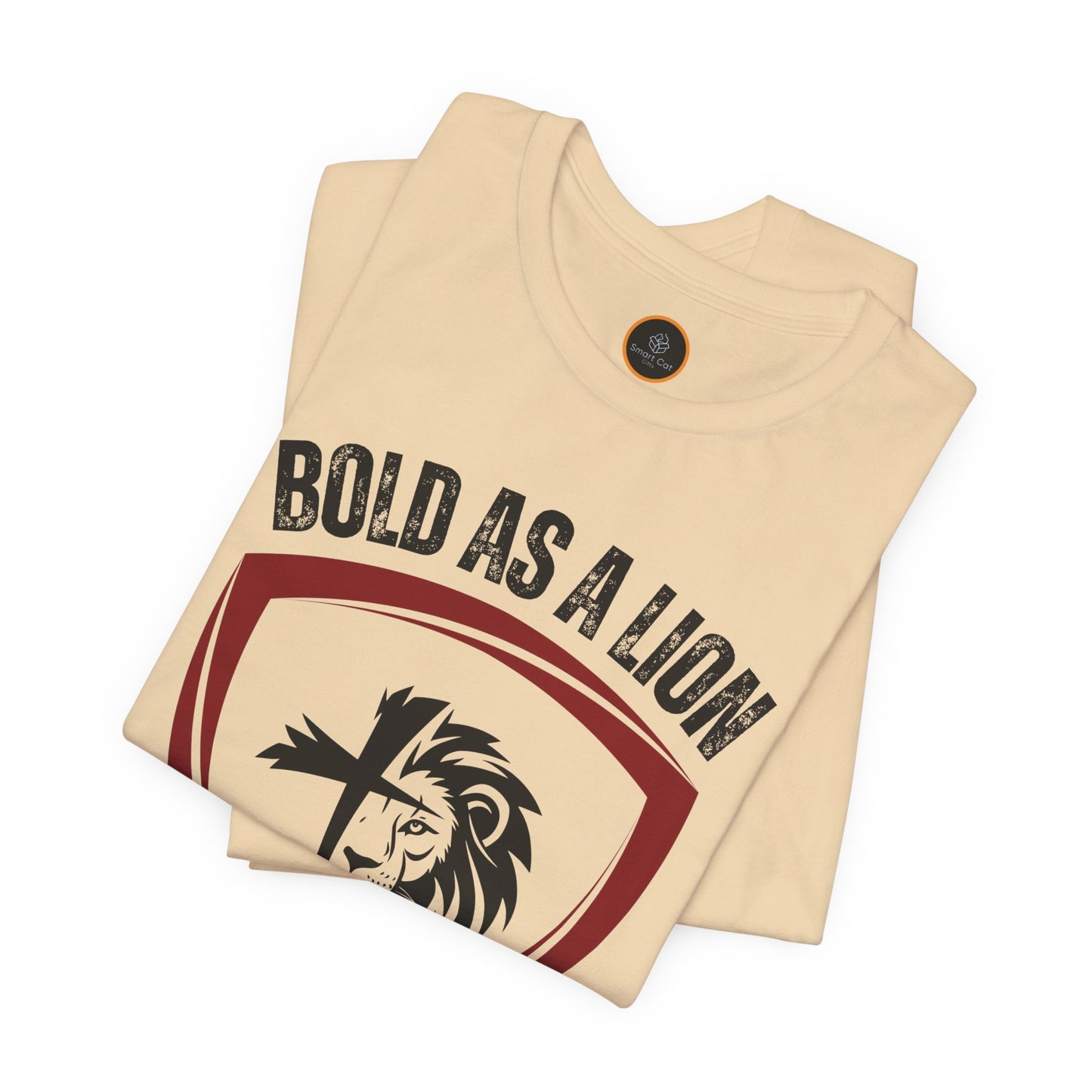 The Bold As A Lion t-shirt: Featuring a graphic with half of a lion's face merging into half of a cross within a shield outline. The text "bold as a lion" is printed above the graphic.