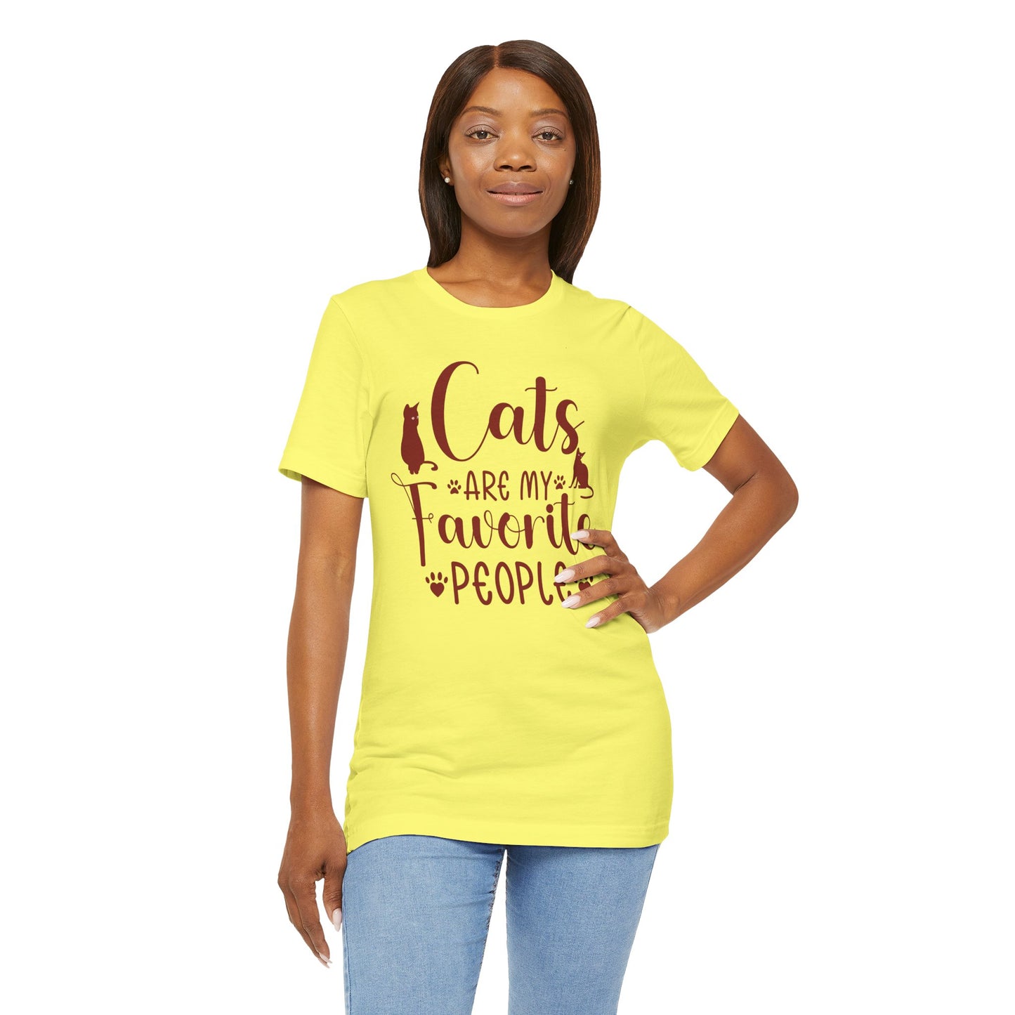 A yellow t-shirt worn by a model displays the text "Cats are my favorite people" in large letters, complemented by a design of four cat paw prints and two cat silhouettes.