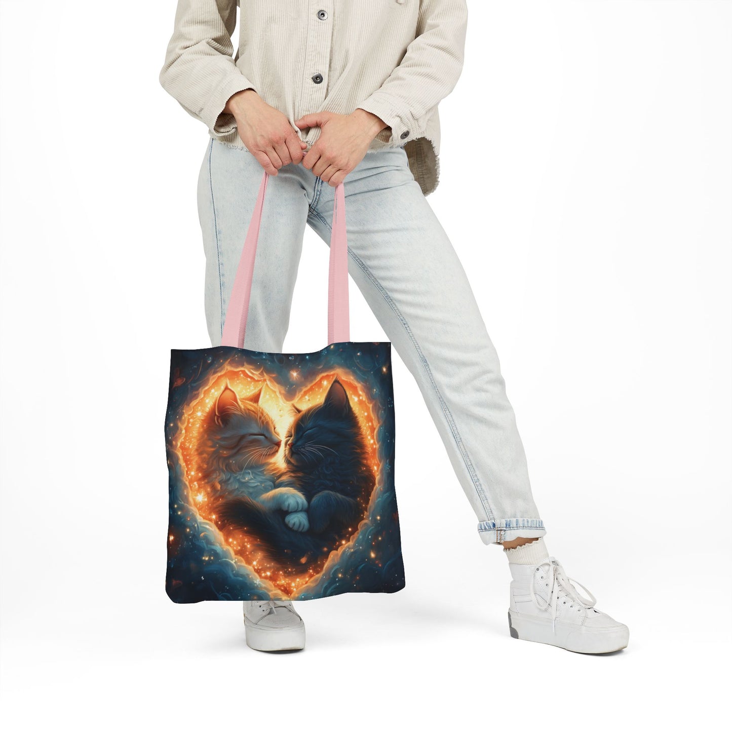 A vibrant heart composed of swirling stardust cradles two cuddling cats against a backdrop of a deep, colorful galaxy. This all-over print design covers the entirety of the Celestial Embrace Tote Bag.