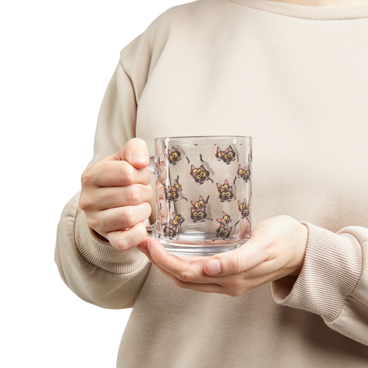 A model holding the clear glass "Morning Meow" mug with an all-over print of a wide-eyed brown cat peering its head through a slice of toast.