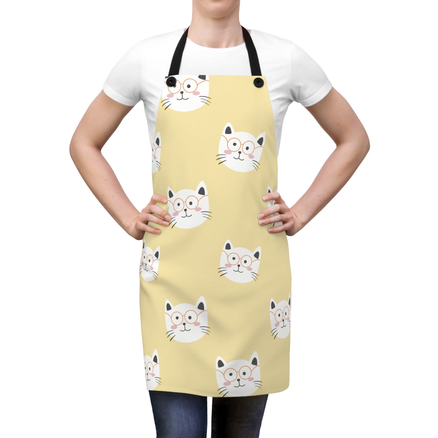 Image of a woman wearing a yellow Chef Happy Cat apron with a graphic of a smiling, white cat's head wearing glasses.