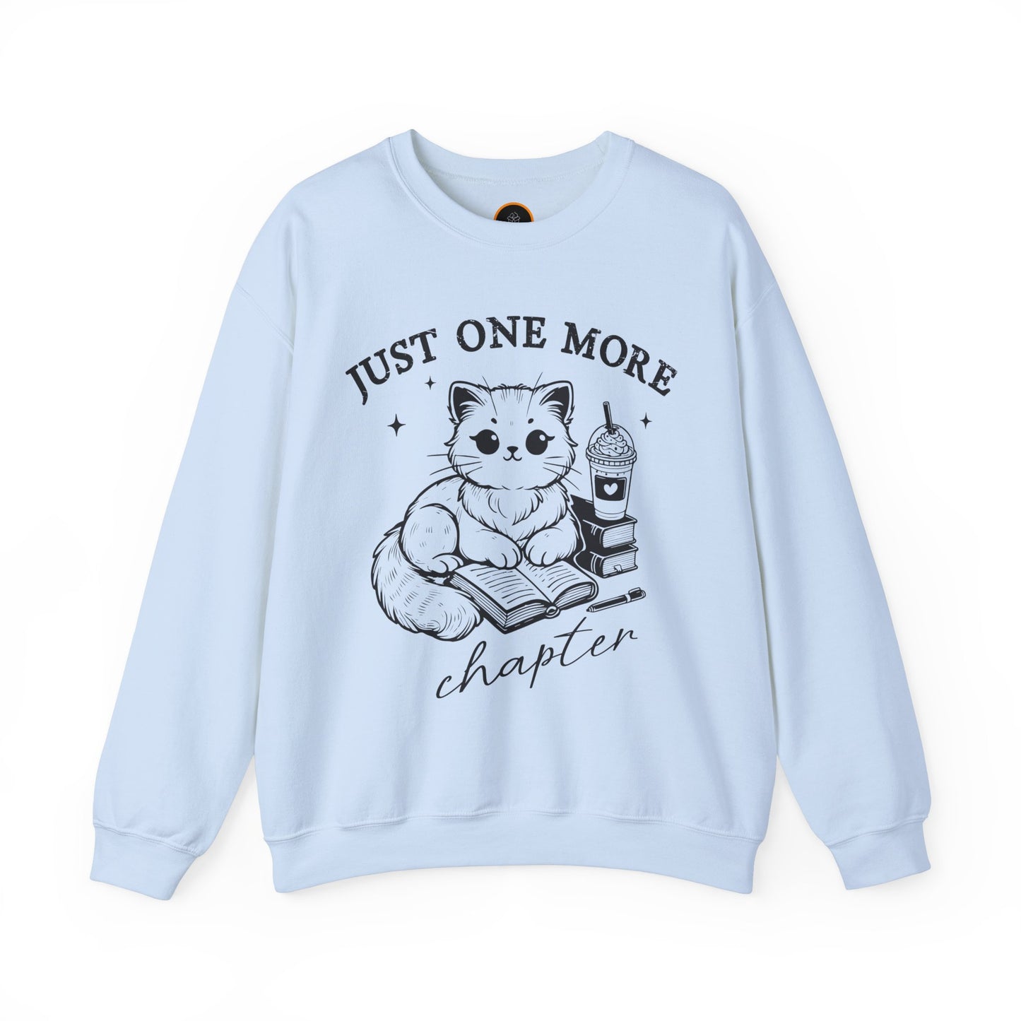 Just One More Chapter" light gray crewneck sweatshirt with a graphic of a cat reading a book next to a Frappuccino on a stack of books.