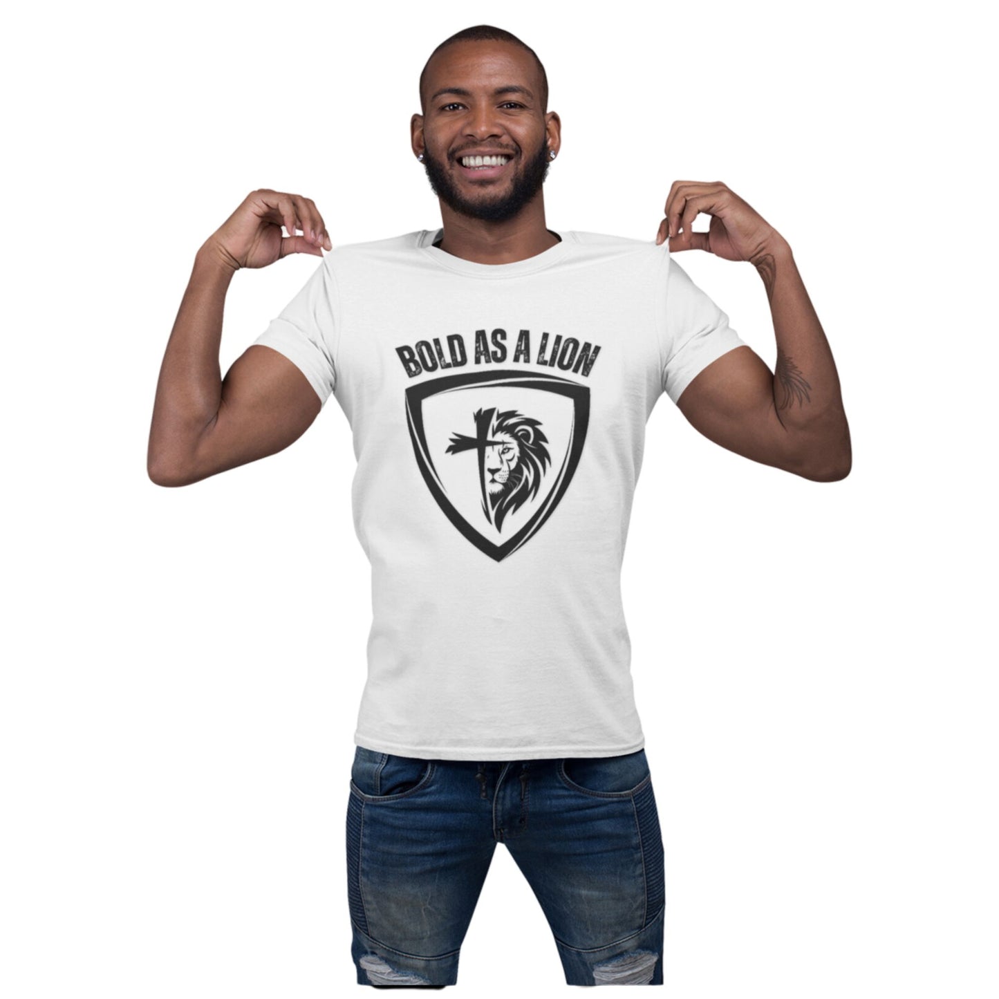 A man models the Bold As A Lion tee. The t-shirt features a graphic with half of a lion's face merging into half of a cross within a shield outline. The text "bold as a lion" is printed above the graphic.