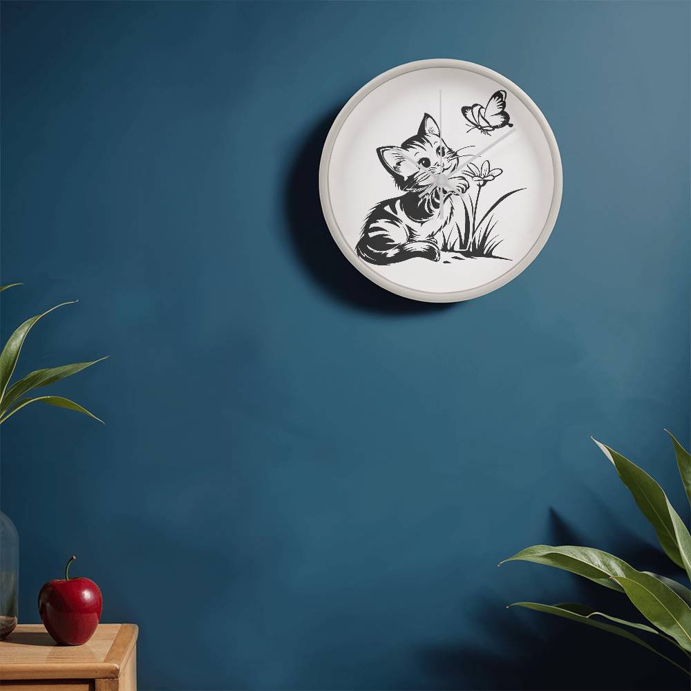 A clock featuring a line art design of a playful encounter between a curious kitten and a gentle butterfly