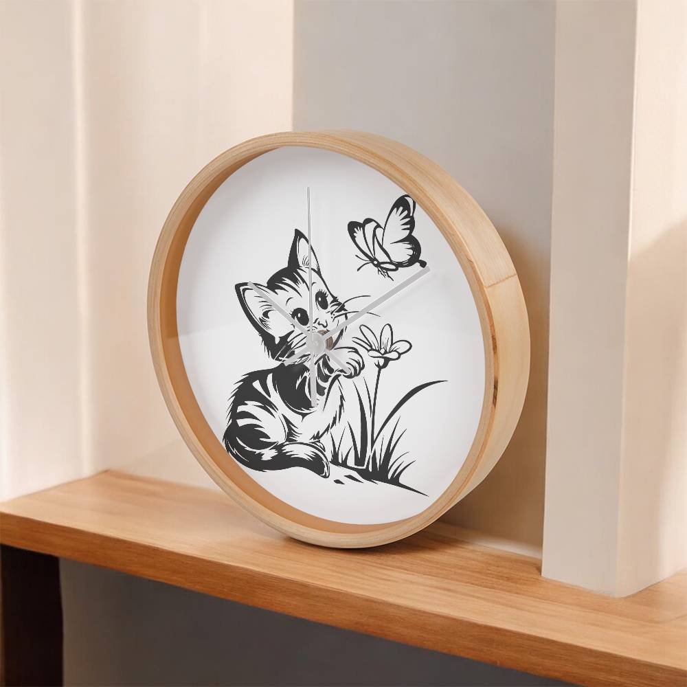 A clock featuring a line art design of a playful encounter between a curious kitten and a gentle butterfly