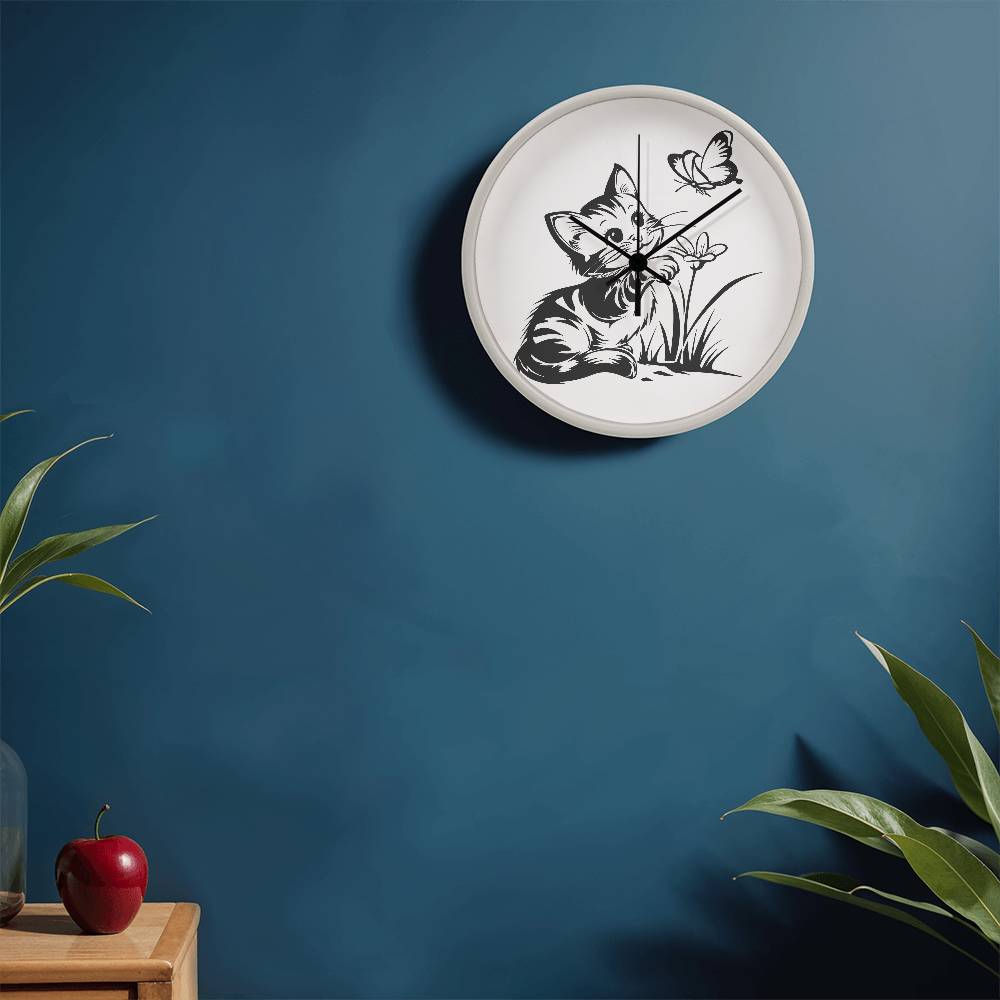 A clock featuring a line art design of a playful encounter between a curious kitten and a gentle butterfly