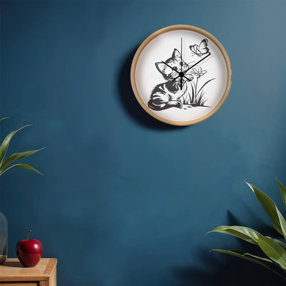 A clock featuring a line art design of a playful encounter between a curious kitten and a gentle butterfly