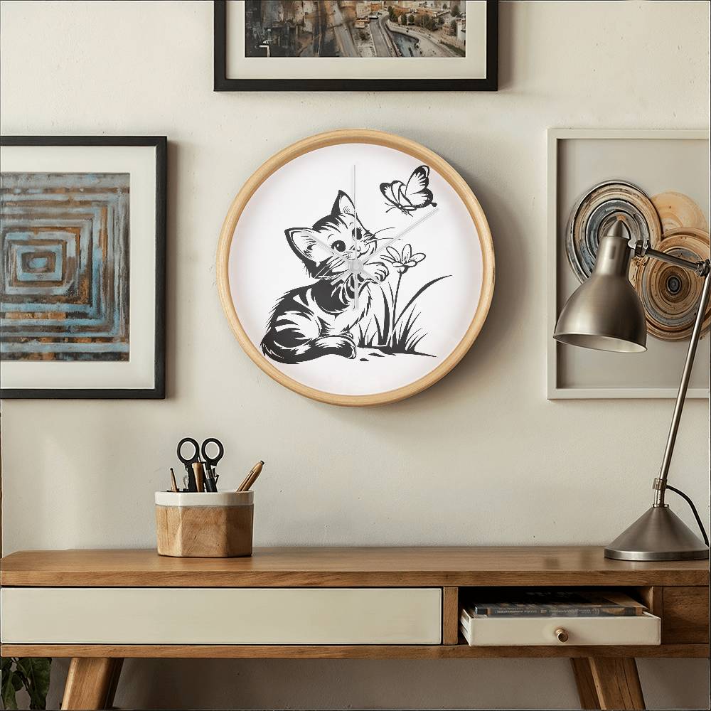 A clock featuring a line art design of a playful encounter between a curious kitten and a gentle butterfly