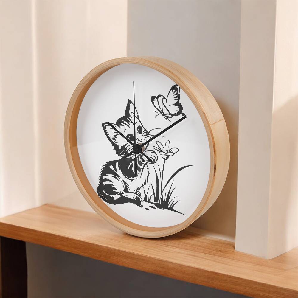 A clock featuring a line art design of a playful encounter between a curious kitten and a gentle butterfly