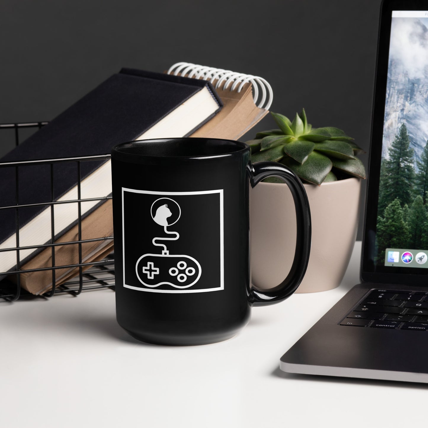 Black "Game On Kitty" mug: Features a white abstract graphic composed entirely of line art shapes within a box, depicting a cat's head connected by a wire to a video game controller.