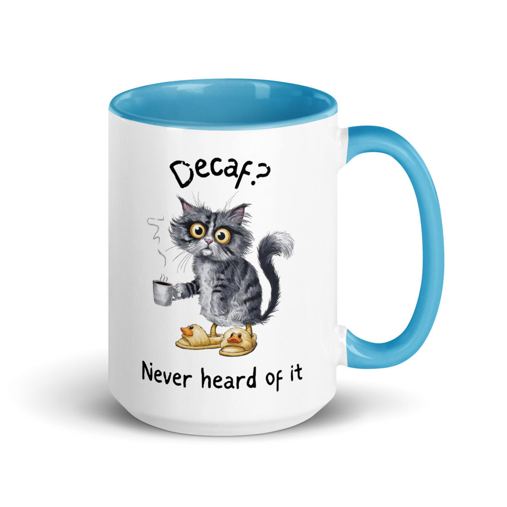 A white and light blue mug featuring an exhausted looking cat wearing yellow slippers with duck faces on them. The cat is holding a steaming mug of coffee. The text on the mug reads "Decaf? Never Heard of It."
