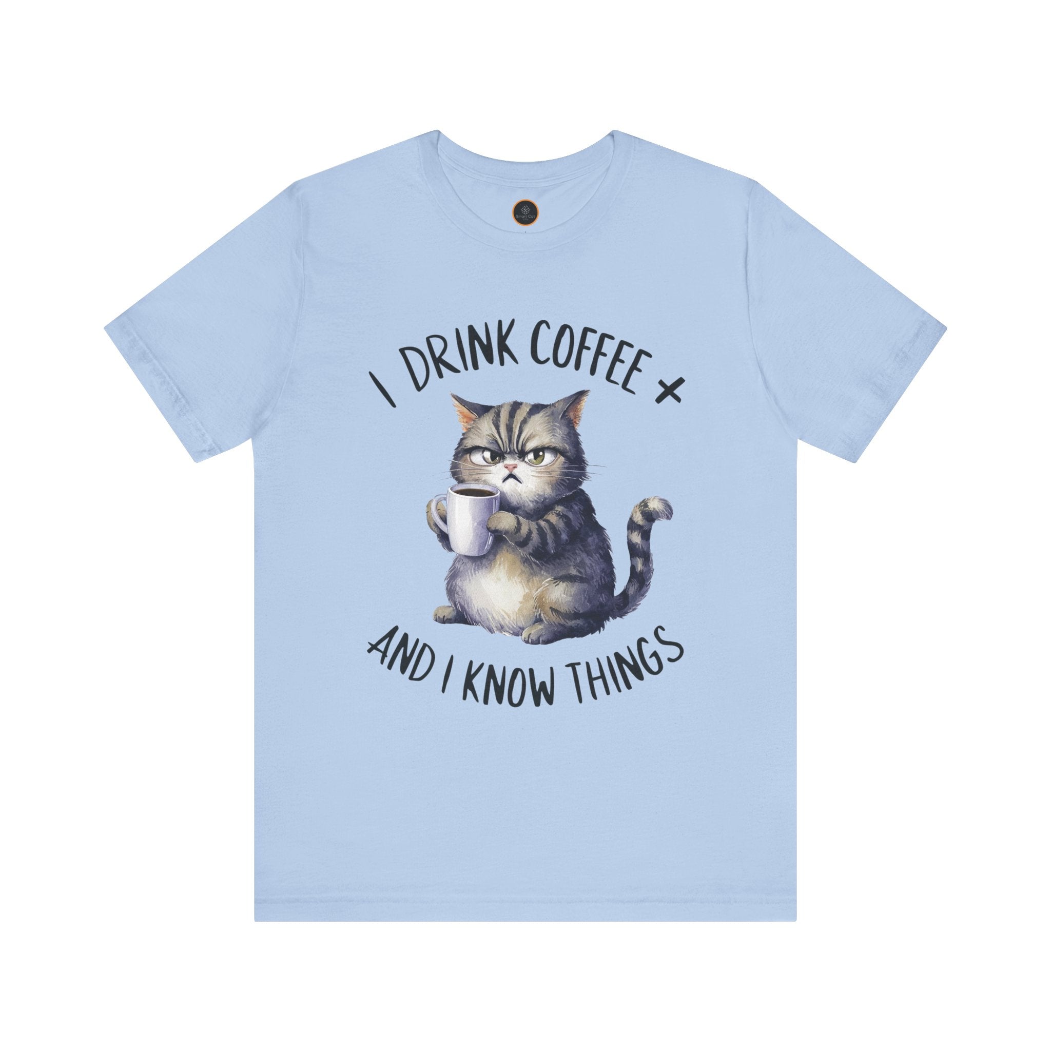 A crew neck t-shirt with the text 'I DRINK COFFEE AND I KNOW THINGS' and an illustration of grumpy a cat holding a coffee cup.