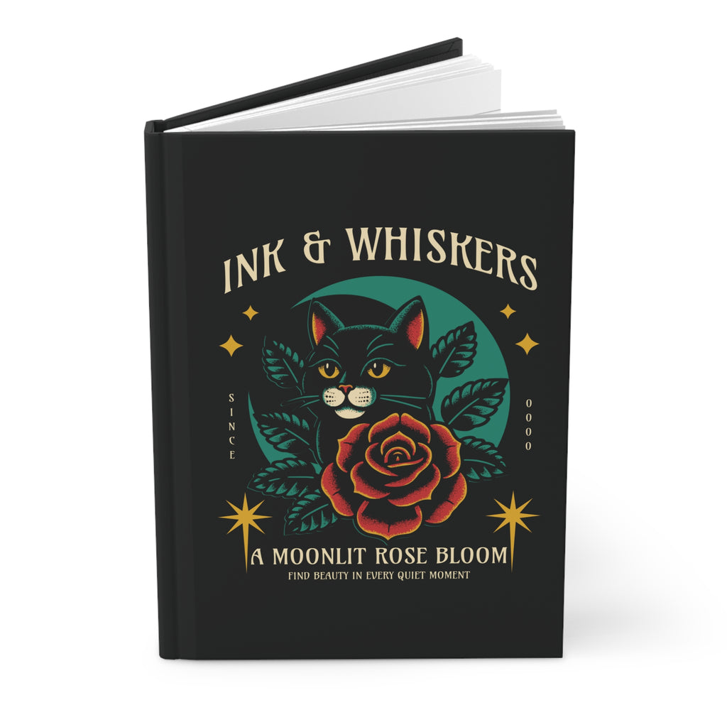 Black notebook with a cat and rose design on the cover, featuring the text 'Ink & Whiskers'.