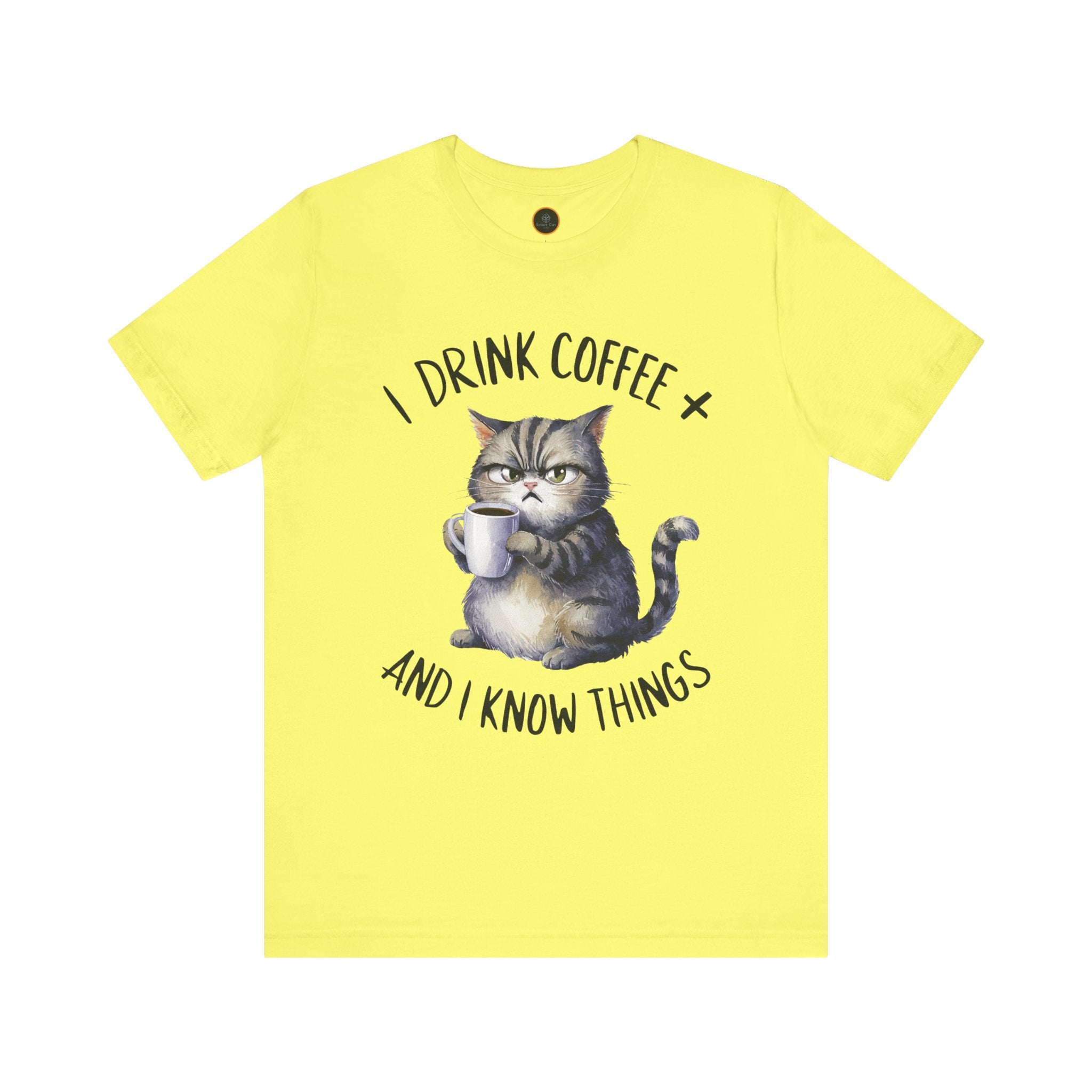 A crew neck t-shirt with the text 'I DRINK COFFEE AND I KNOW THINGS' and an illustration of grumpy a cat holding a coffee cup.