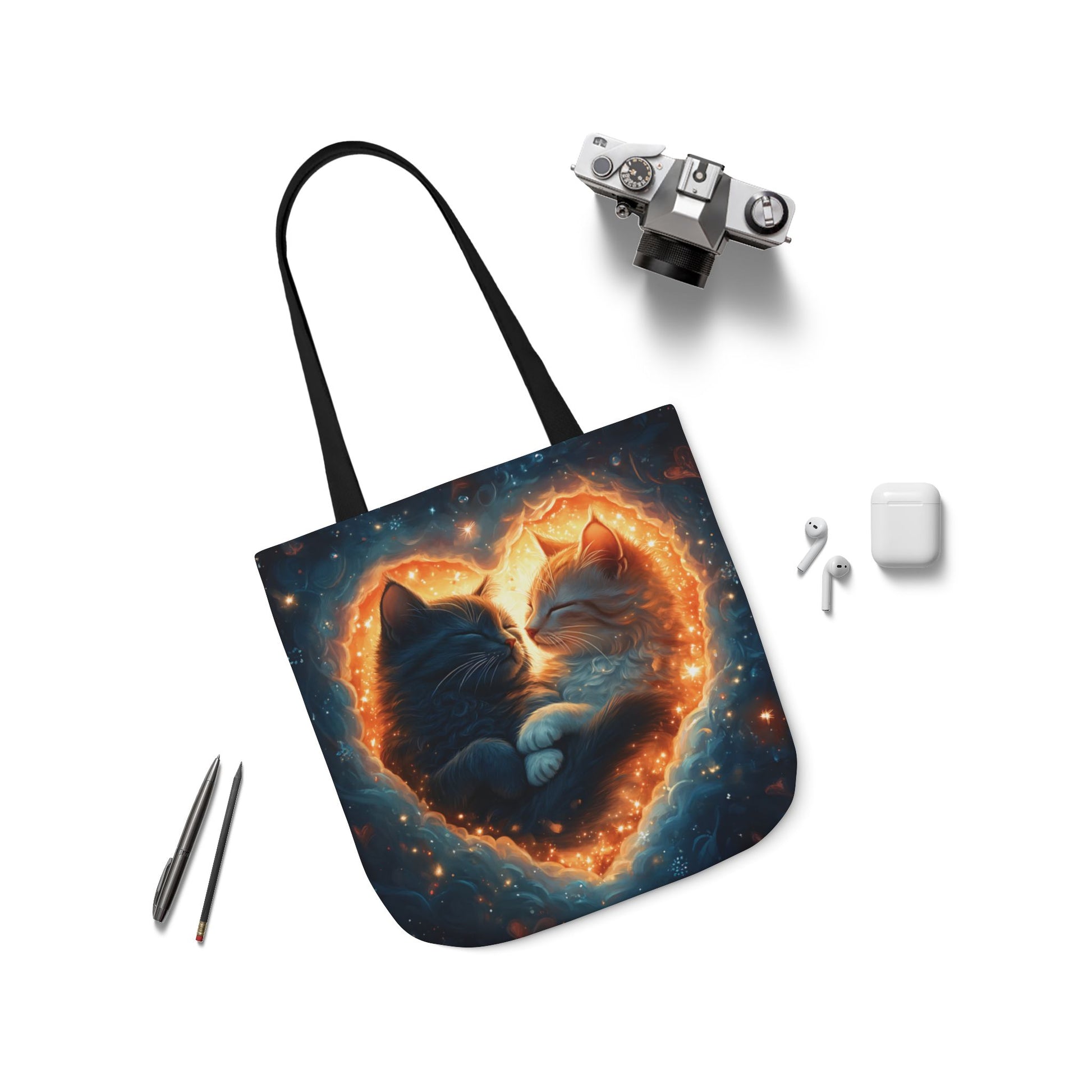 A vibrant heart composed of swirling stardust cradles two cuddling cats against a backdrop of a deep, colorful galaxy. This all-over print design covers the entirety of the Celestial Embrace Tote Bag.