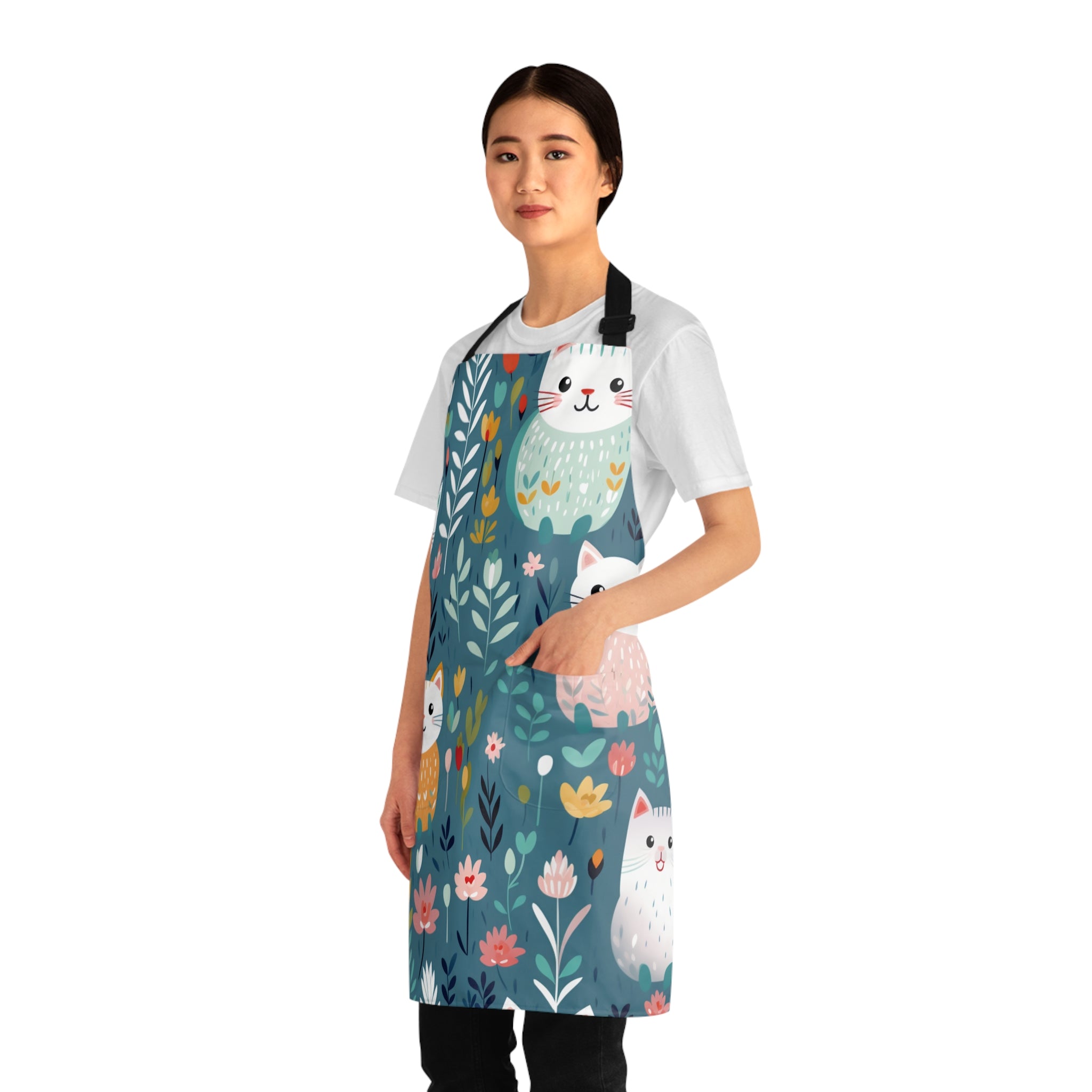 Model wearing a colorful apron with cat and floral design