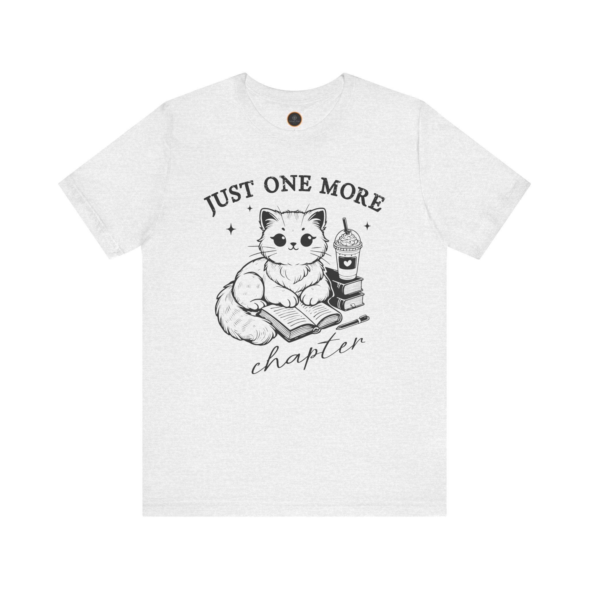 The "Just One More Chapter" t-shirt depicting a cat reading an open book beside a book stack topped with a beverage. The words "just one more" are above, and "chapter" in script is below.