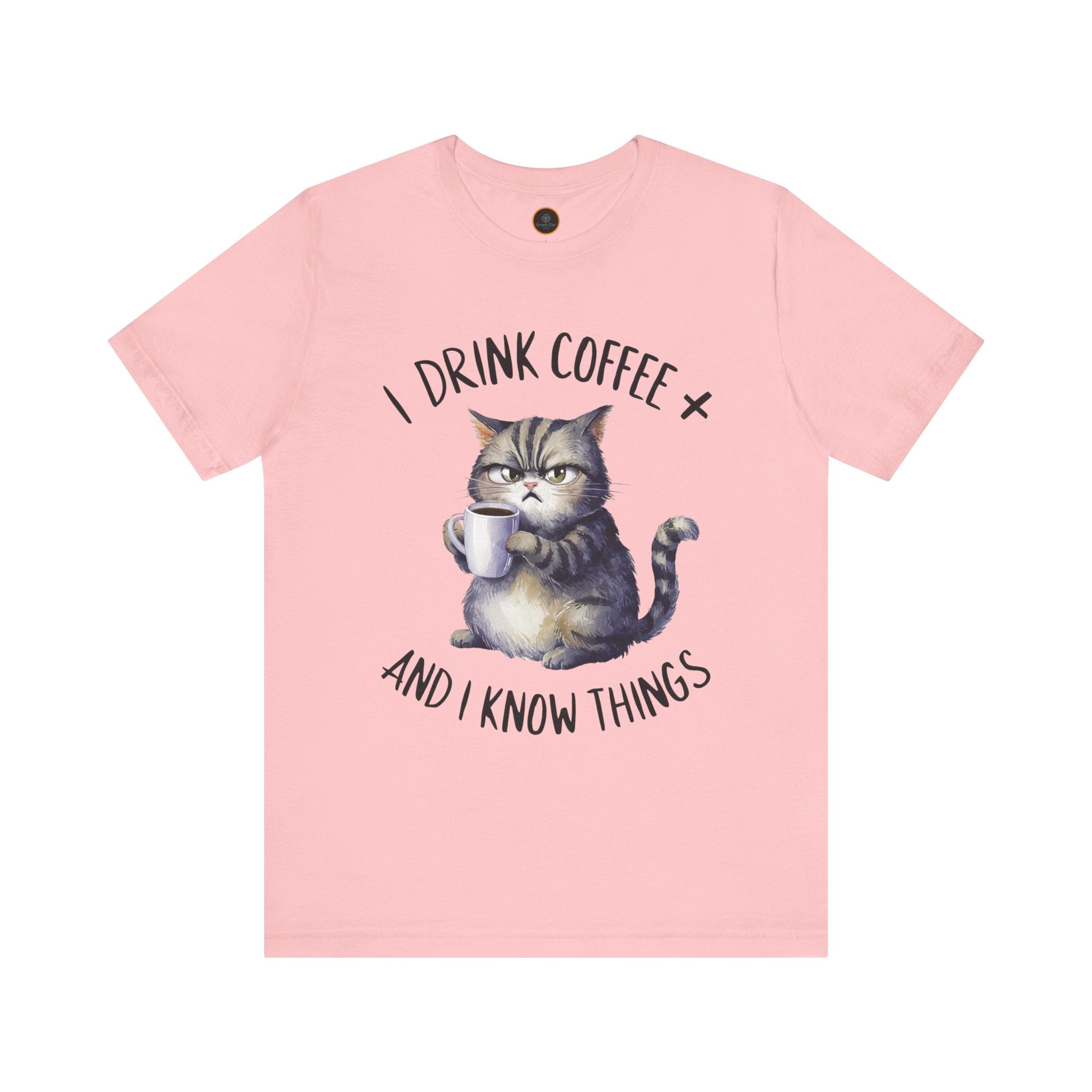A crew neck t-shirt with the text 'I DRINK COFFEE AND I KNOW THINGS' and an illustration of grumpy a cat holding a coffee cup.