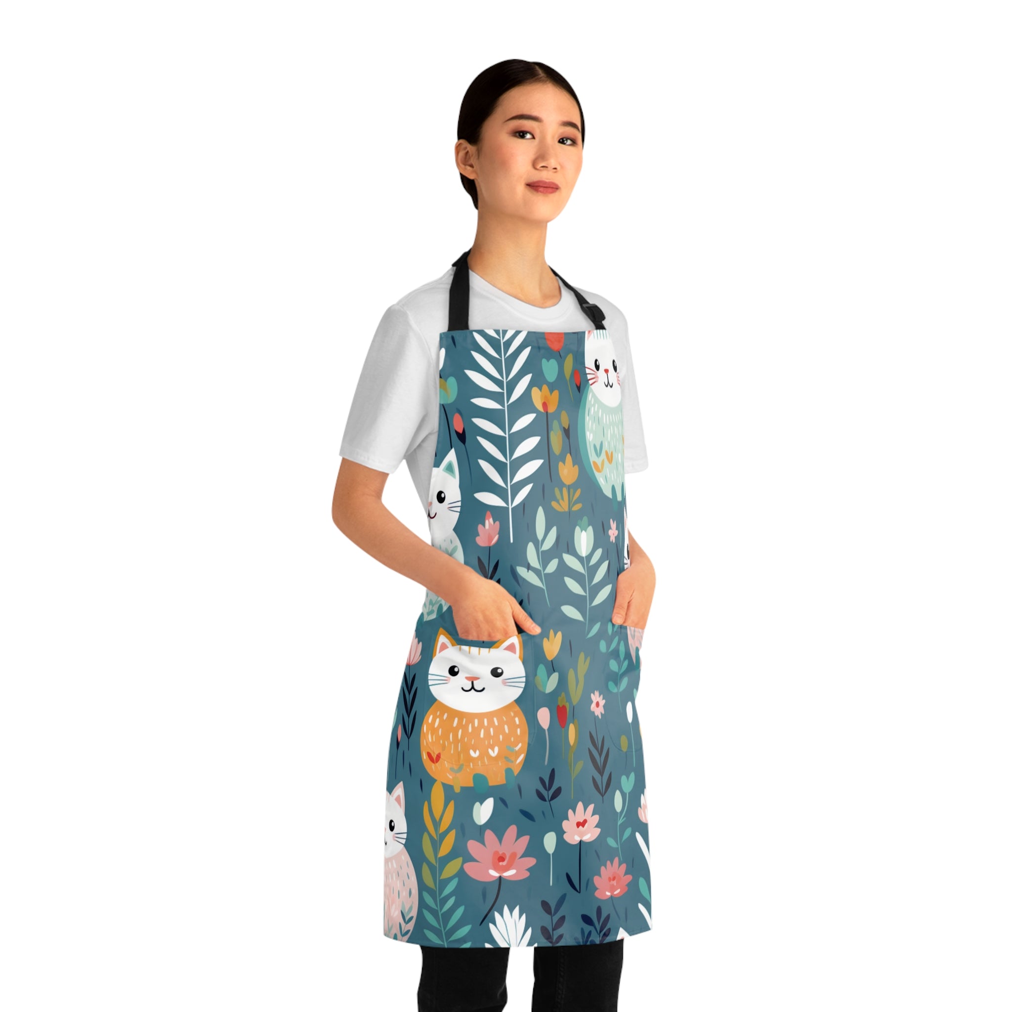 Model wearing a colorful apron with cat and floral design 
