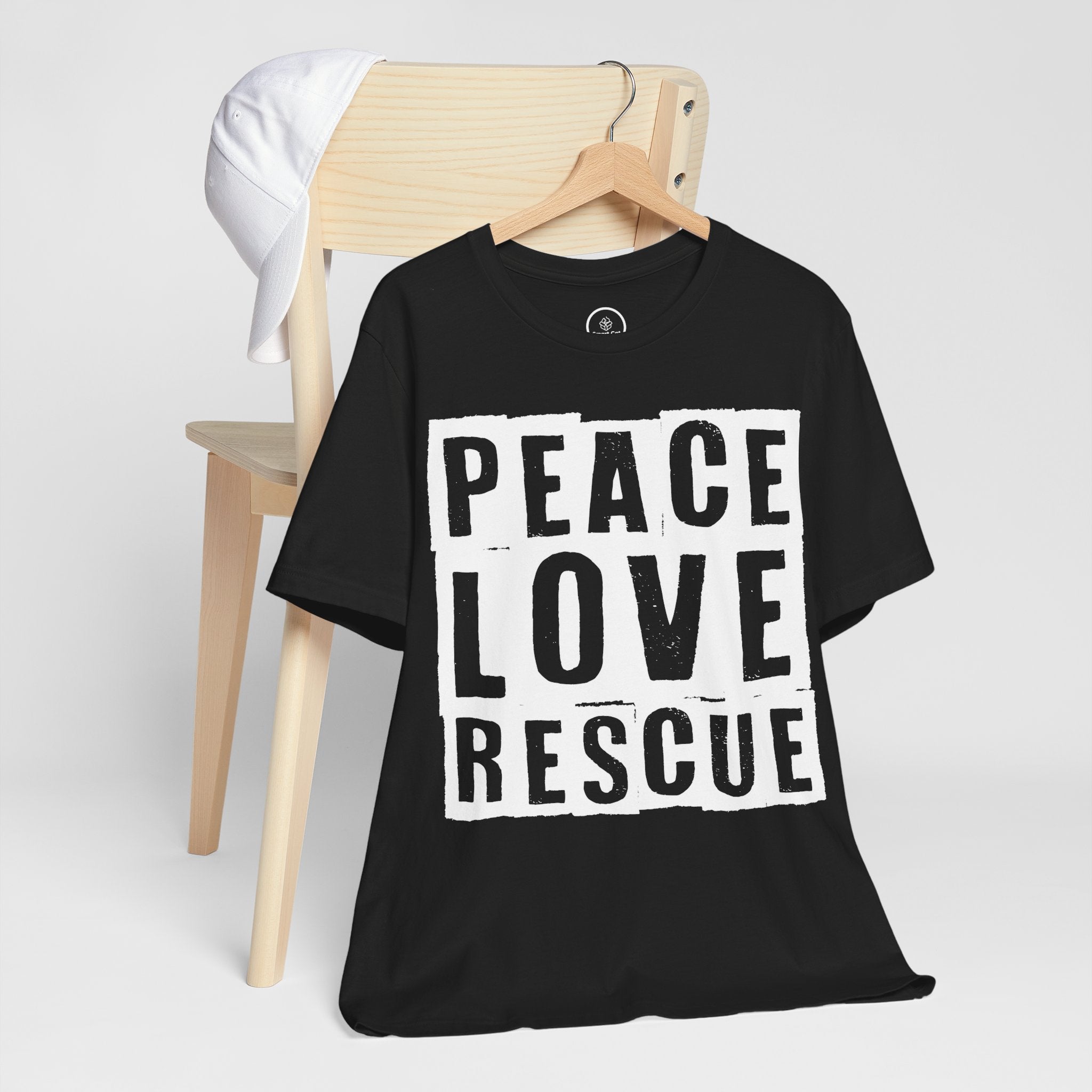 Black t-shirt, front view, white "Peace Love Rescue" graphic, on hanger