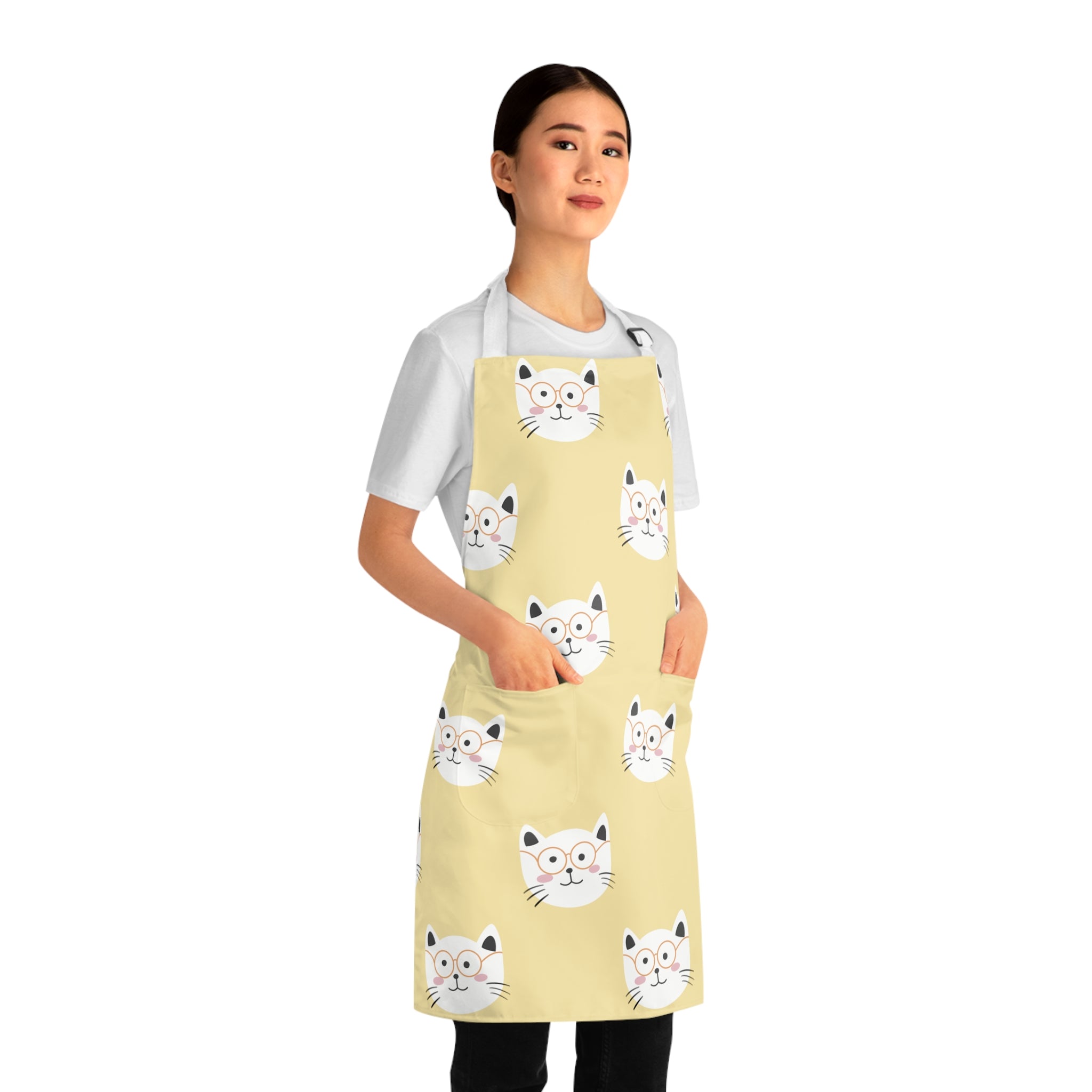 Model wearing a yellow apron with smiling cat pattern