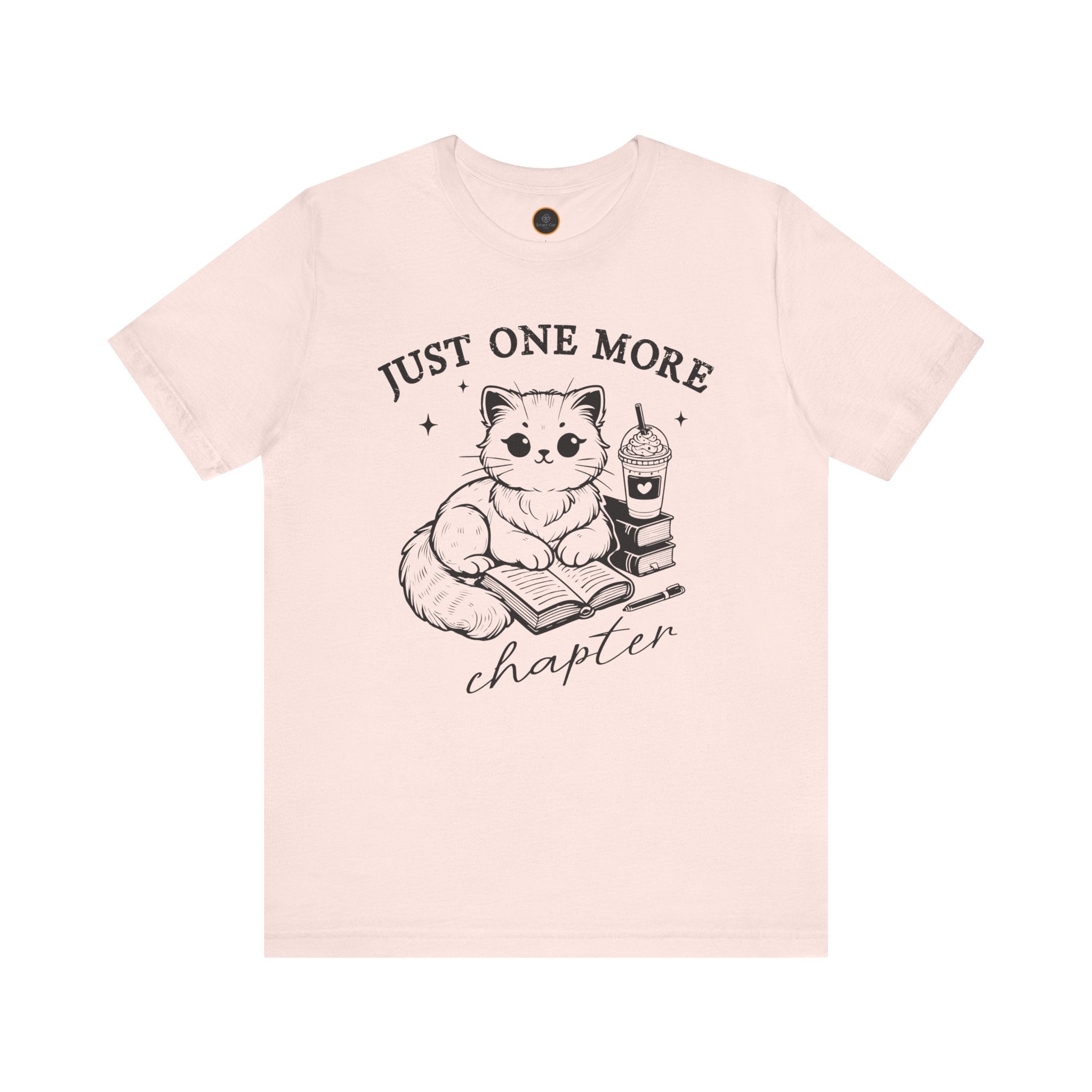 The "Just One More Chapter" t-shirt depicting a cat reading an open book beside a book stack topped with a beverage. The words "just one more" are above, and "chapter" in script is below.