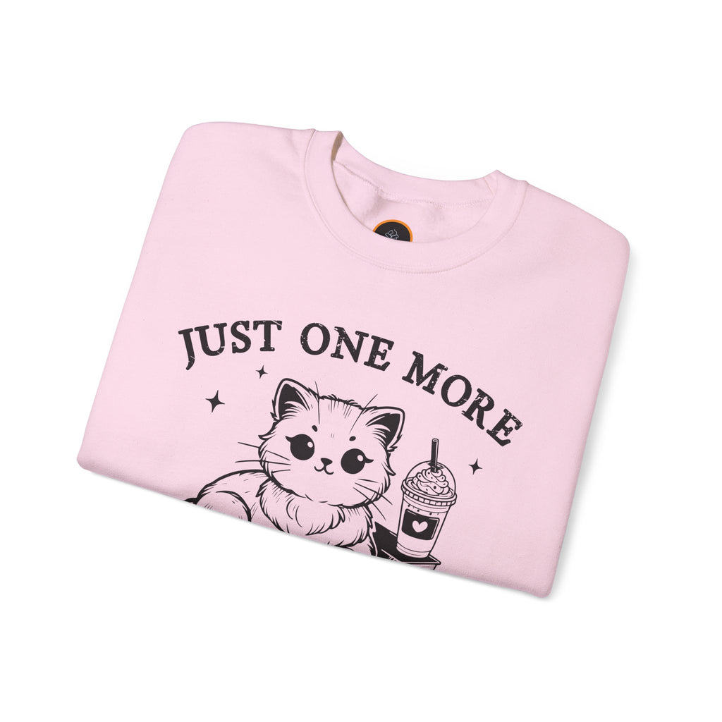 Just One More Chapter" light gray crewneck sweatshirt with a graphic of a cat reading a book next to a Frappuccino on a stack of books.