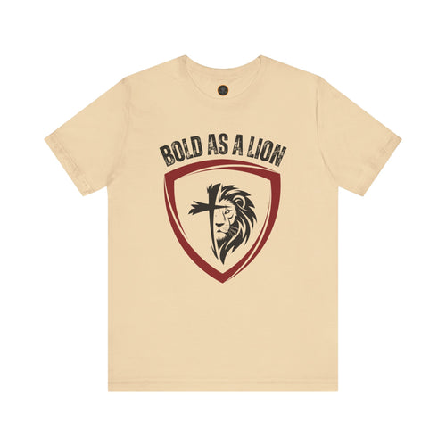 The Bold As A Lion t-shirt: Featuring a graphic with half of a lion's face merging into half of a cross within a shield outline. The text "bold as a lion" is printed above the graphic.