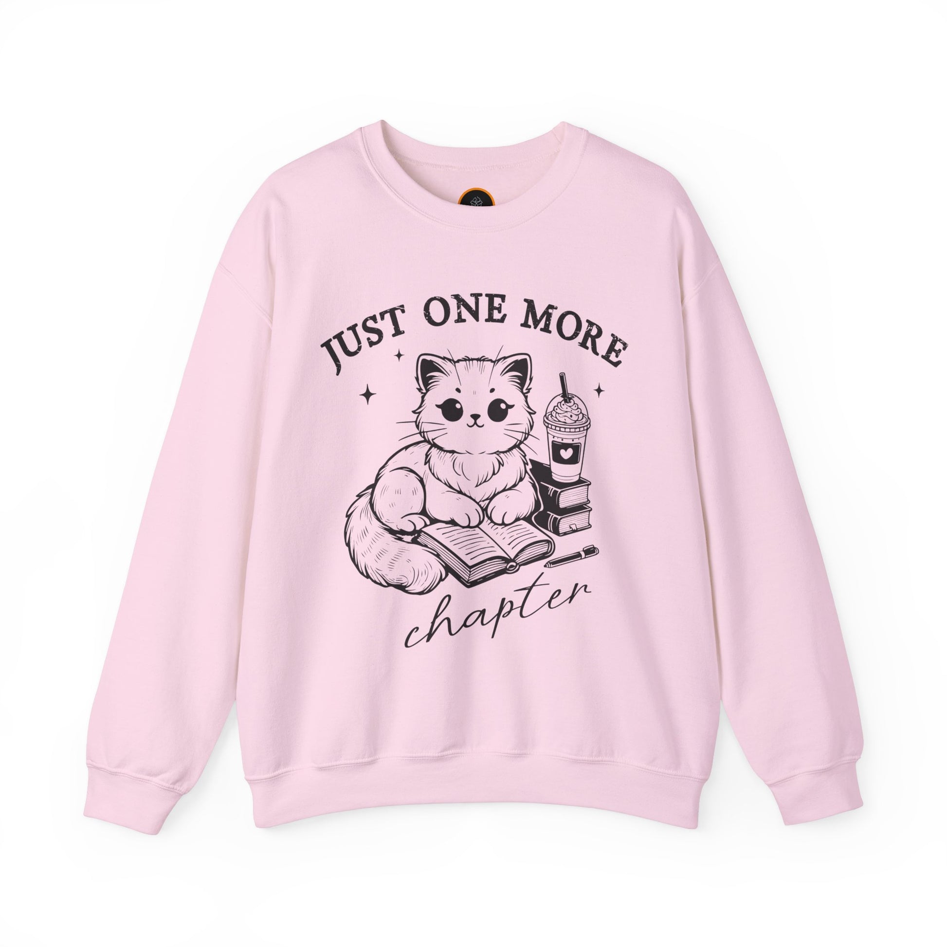 Just One More Chapter" light gray crewneck sweatshirt with a graphic of a cat reading a book next to a Frappuccino on a stack of books.