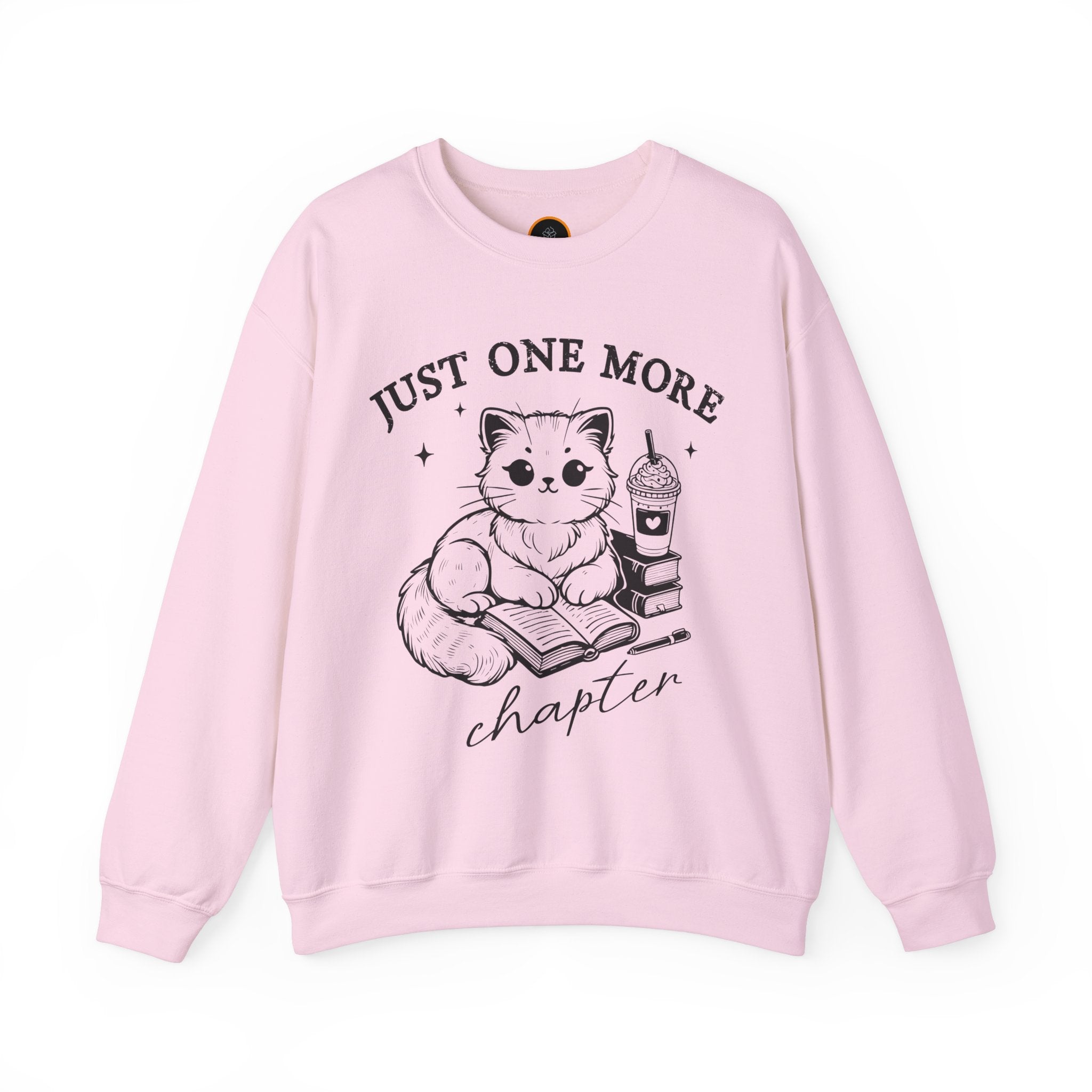 Just One More Chapter" light gray crewneck sweatshirt with a graphic of a cat reading a book next to a Frappuccino on a stack of books.