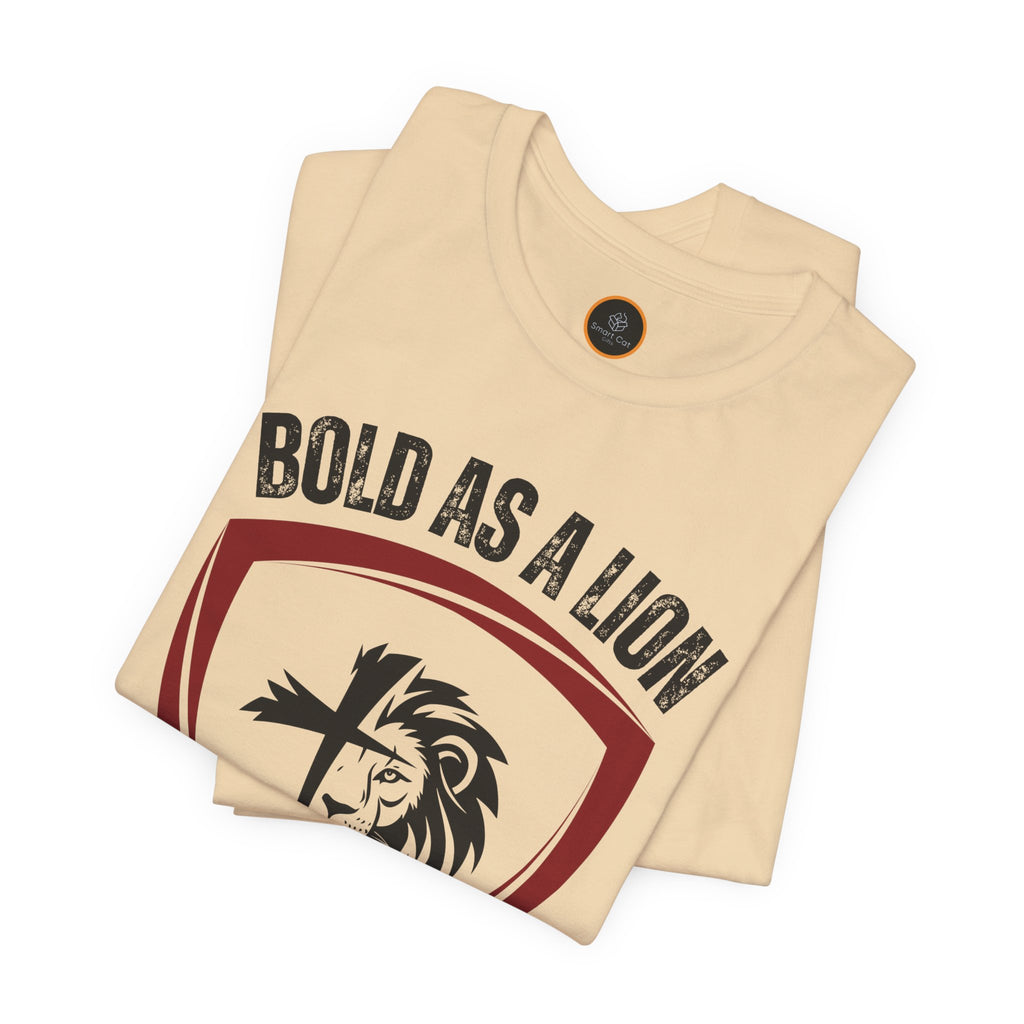 The Bold As A Lion t-shirt: Featuring a graphic with half of a lion's face merging into half of a cross within a shield outline. The text "bold as a lion" is printed above the graphic.