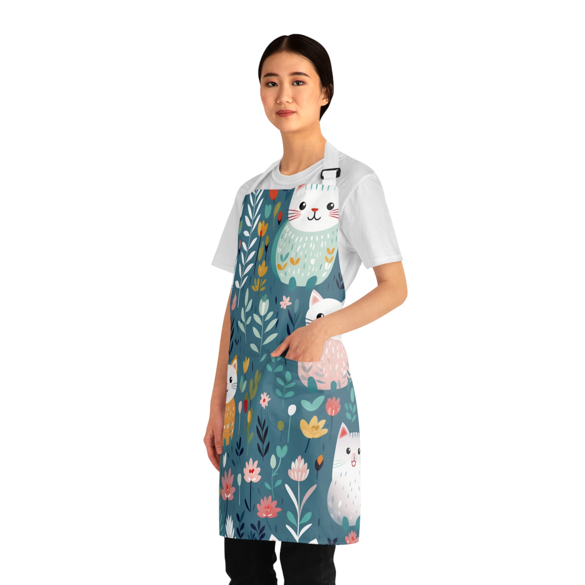 Model wearing a colorful apron with cat and floral design