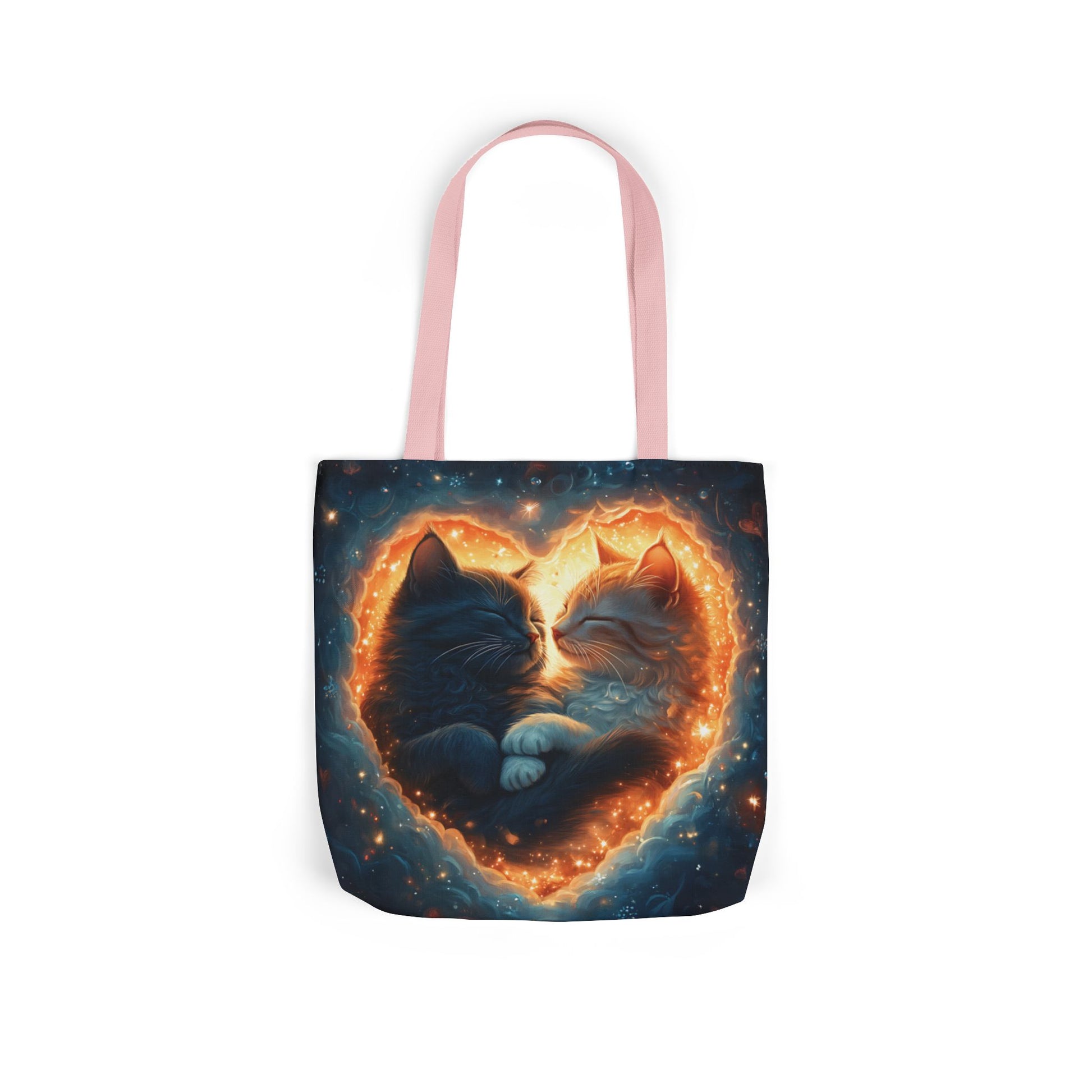 A vibrant heart composed of swirling stardust cradles two cuddling cats against a backdrop of a deep, colorful galaxy. This all-over print design covers the entirety of the Celestial Embrace Tote Bag.