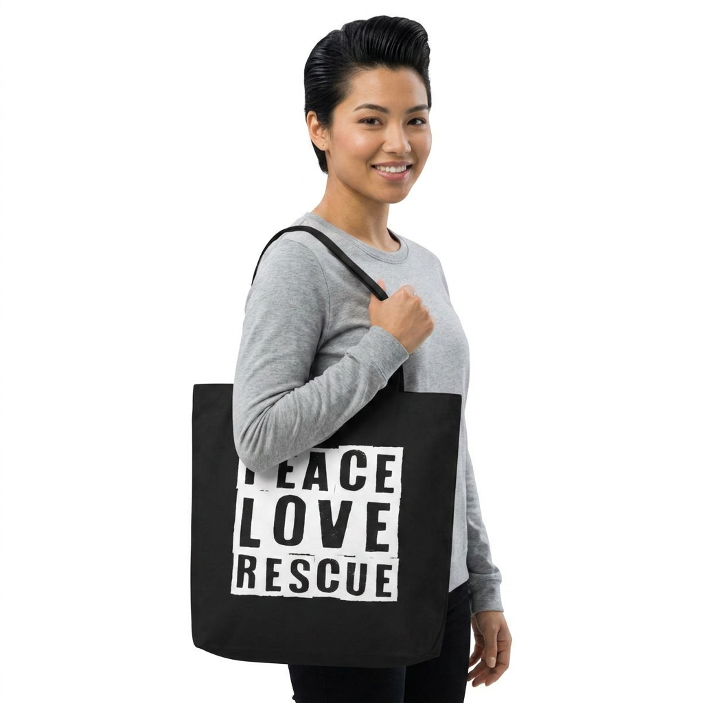 Model wearing a black canvas tote with Peace Love Rescue graphic over her right shoulder