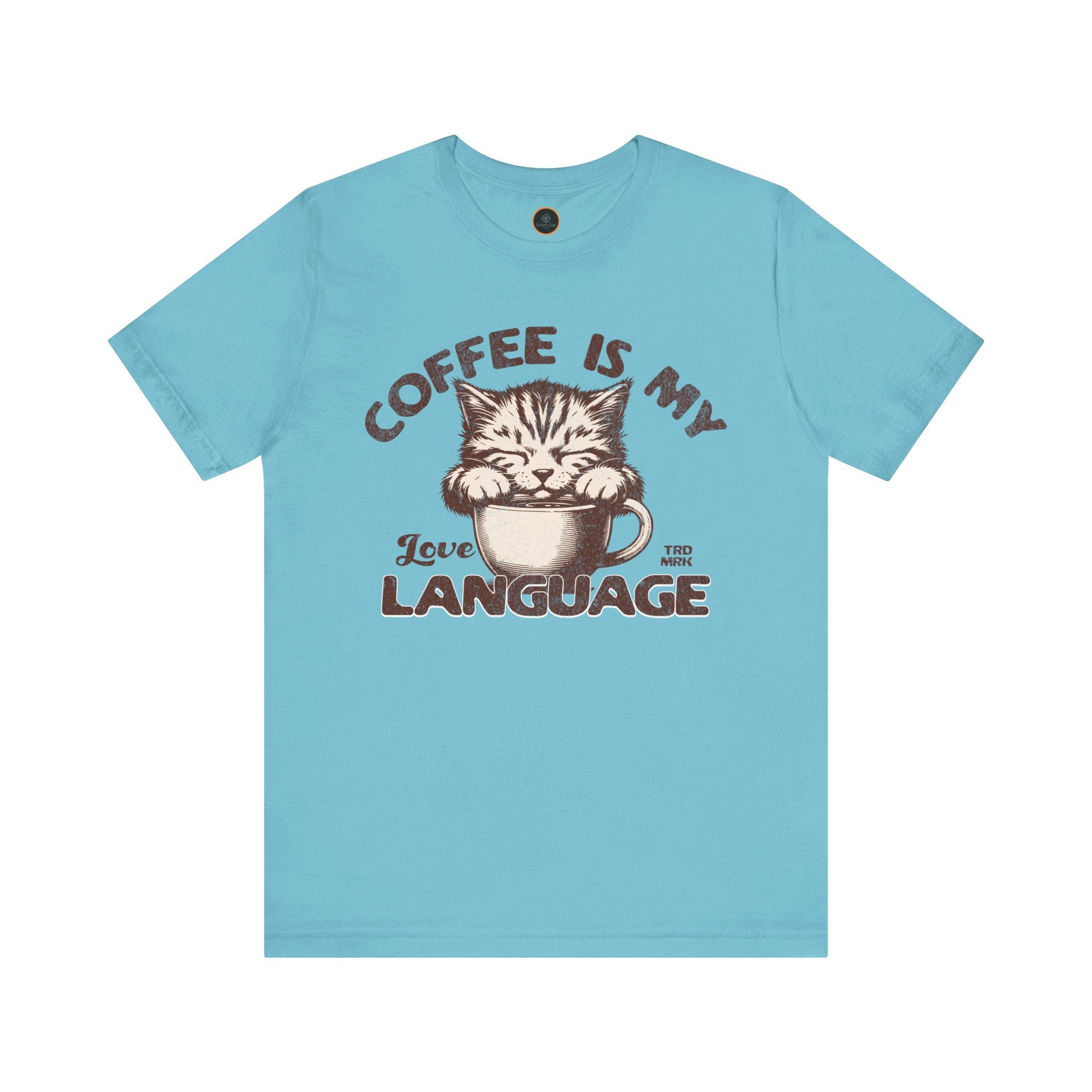 A  crew neck t-shirt with the text 'COFFEE IS MY LANGUAGE' and a graphic of a cat.
