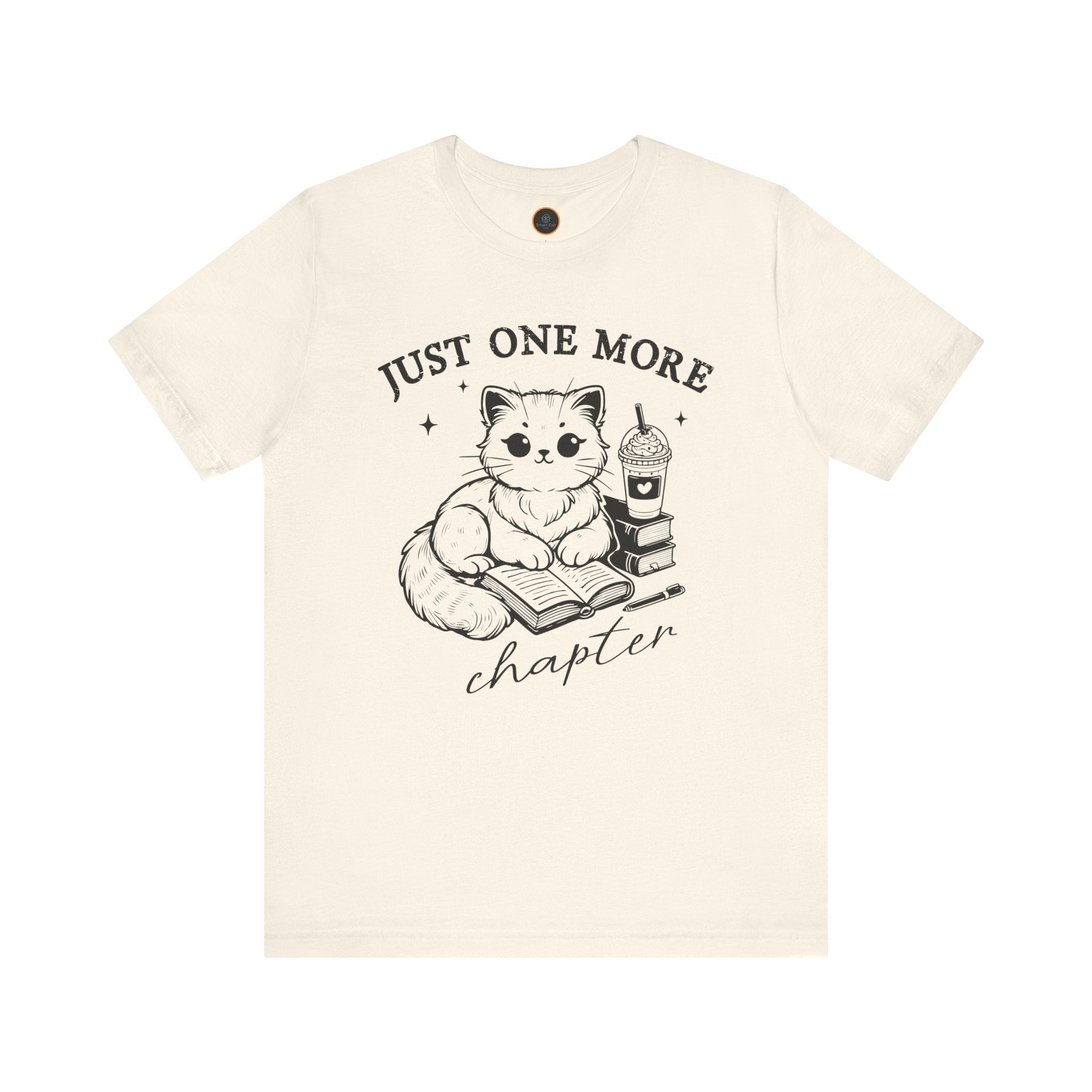 The "Just One More Chapter" t-shirt depicting a cat reading an open book beside a book stack topped with a beverage. The words "just one more" are above, and "chapter" in script is below.
