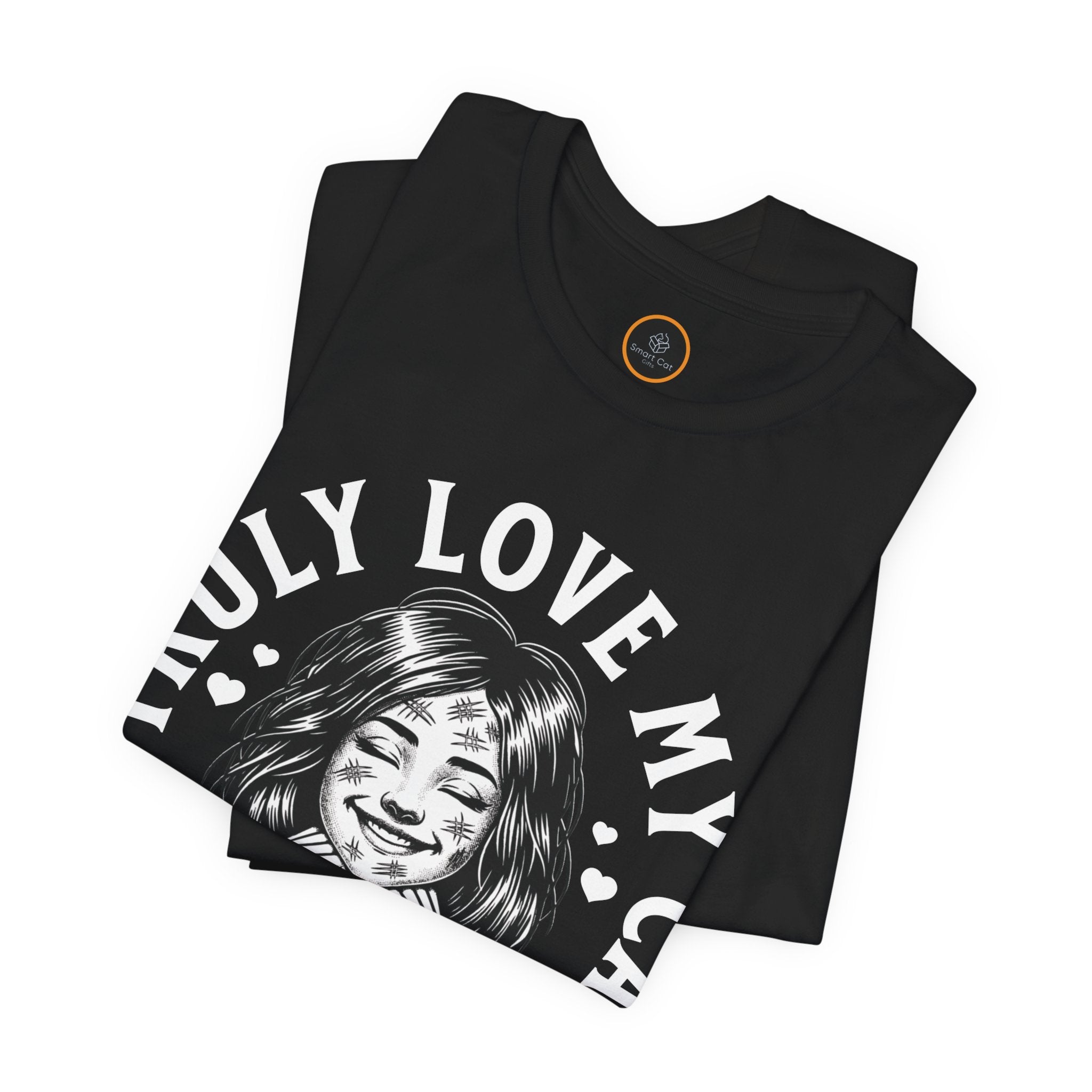 Humorous graphic tee design showing a smiling woman covered in cat scratches, with a smug cat nearby and hearts, above the text 'I Truly Love My Cat'."