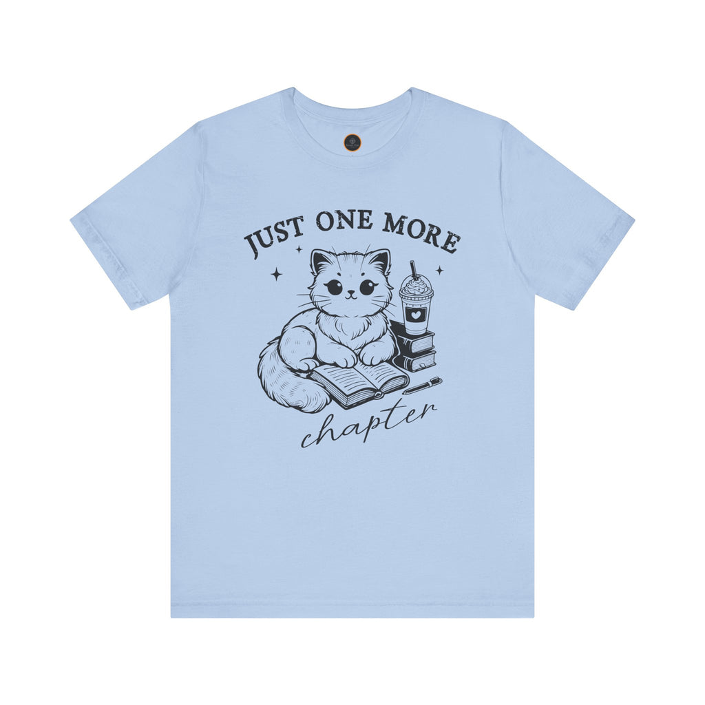 The "Just One More Chapter" t-shirt depicting a cat reading an open book beside a book stack topped with a beverage. The words "just one more" are above, and "chapter" in script is below.