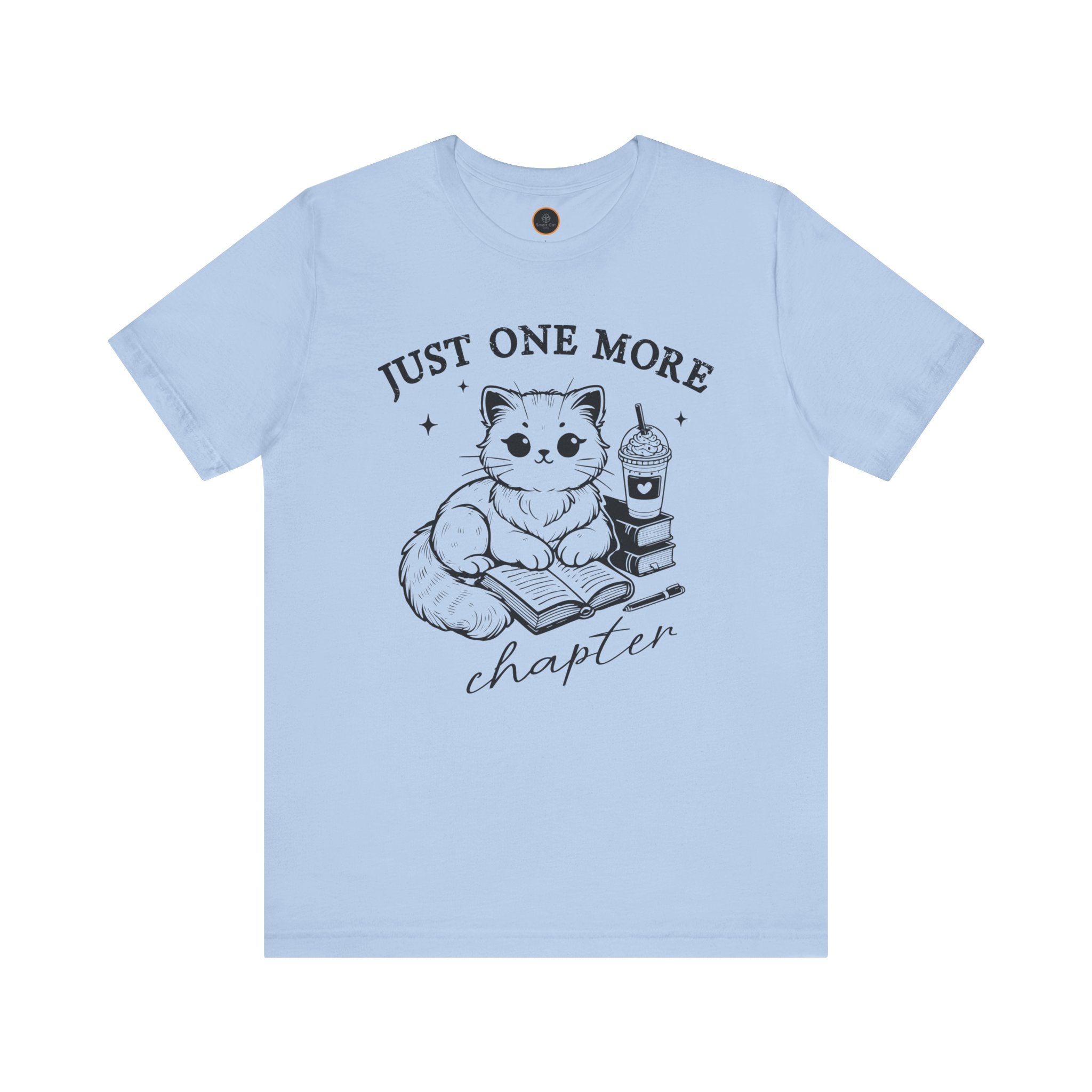 The "Just One More Chapter" t-shirt depicting a cat reading an open book beside a book stack topped with a beverage. The words "just one more" are above, and "chapter" in script is below.