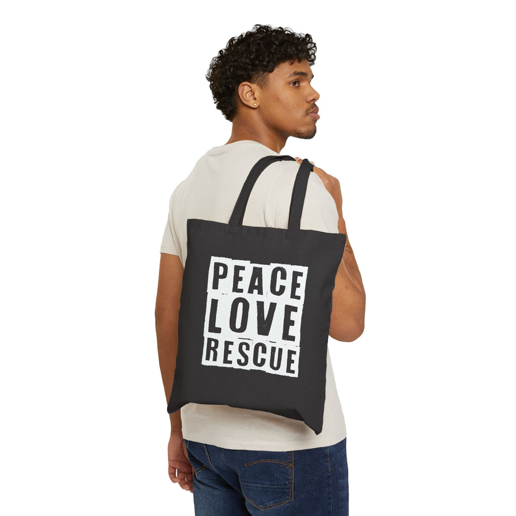 Model wearing black canvas tote with Peace Love Rescue graphic , back view