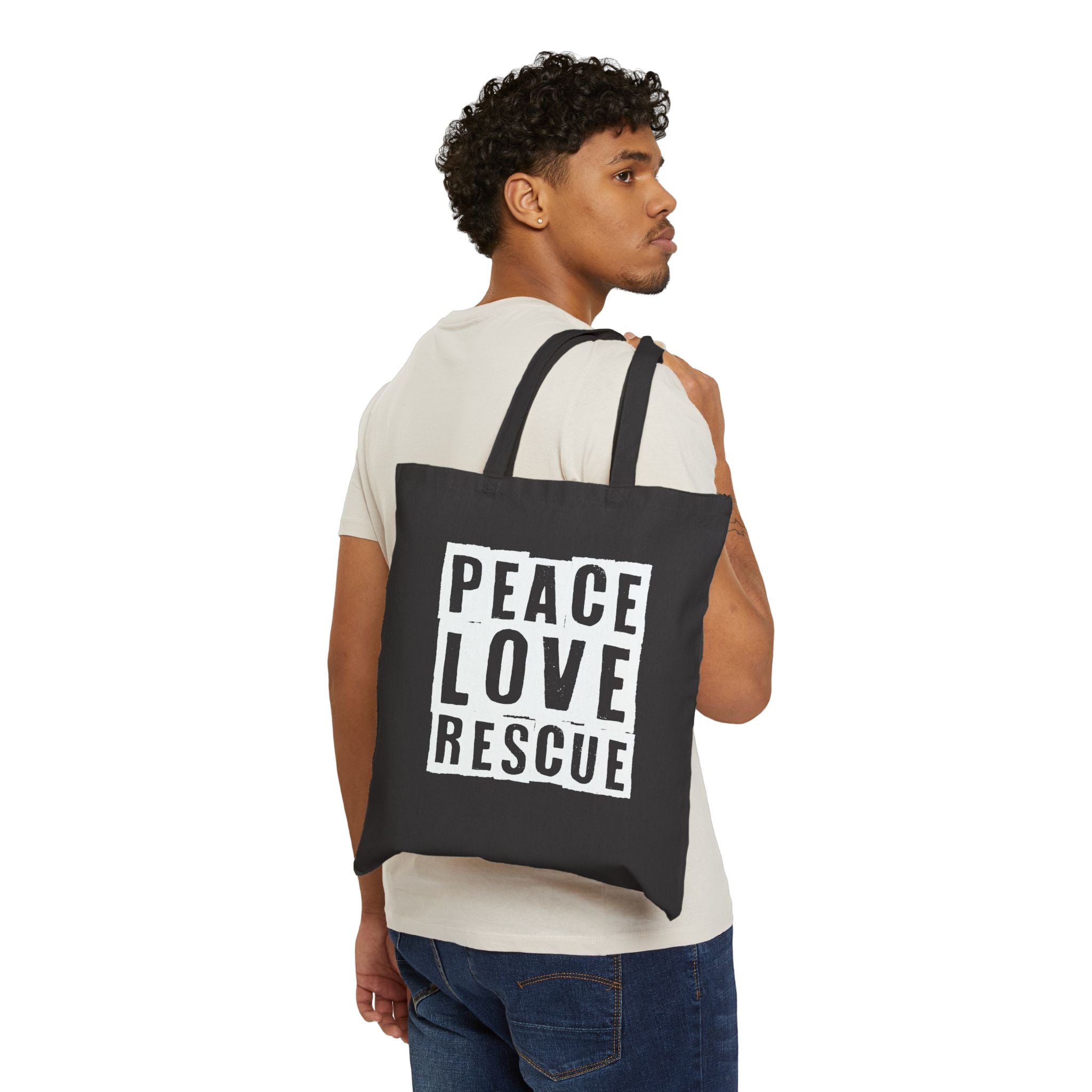 Model wearing black canvas tote with Peace Love Rescue graphic , back view
