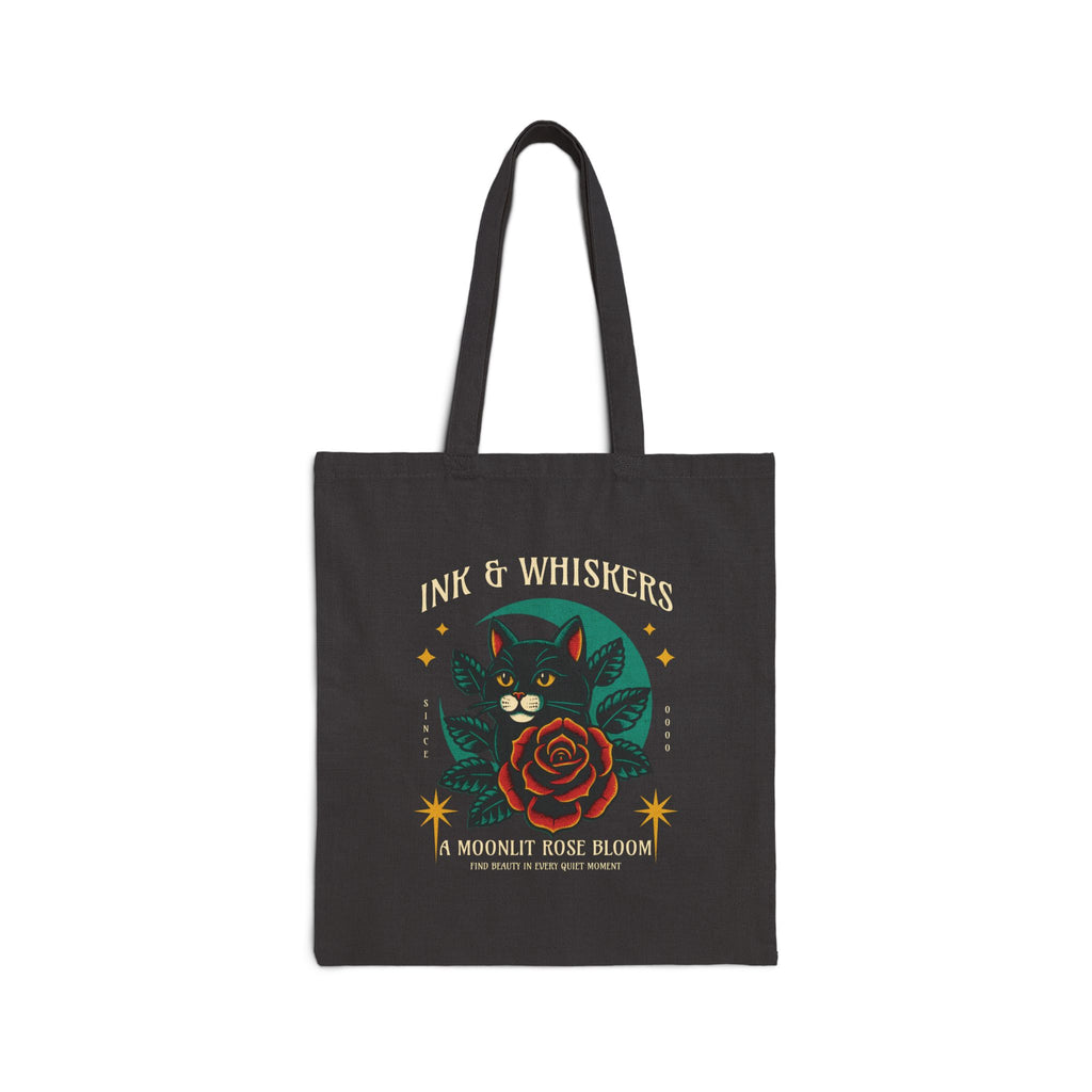 Black tote bag with cat and rose design and 'Ink & Whiskers' text.