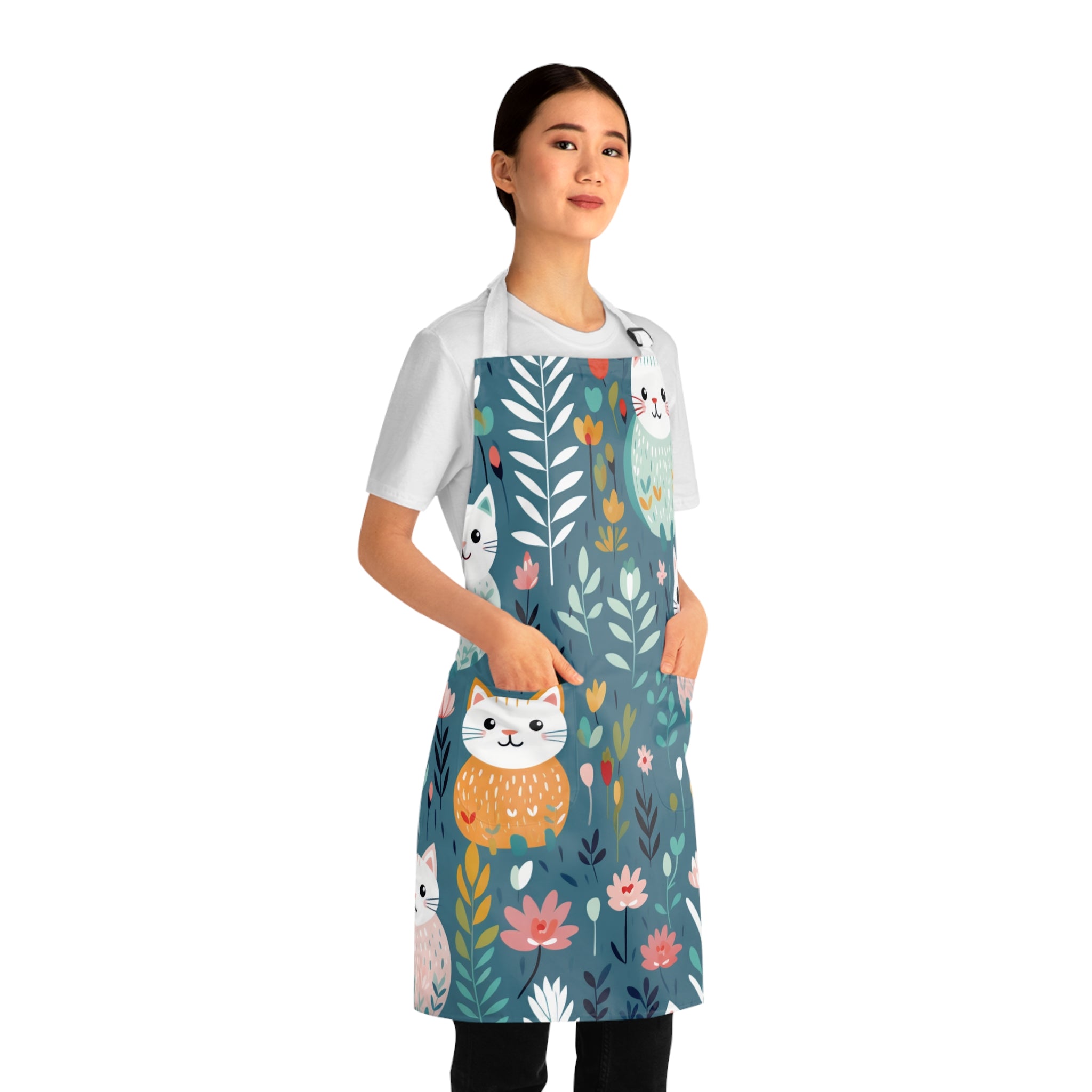 Model wearing a colorful apron with cat and floral design 