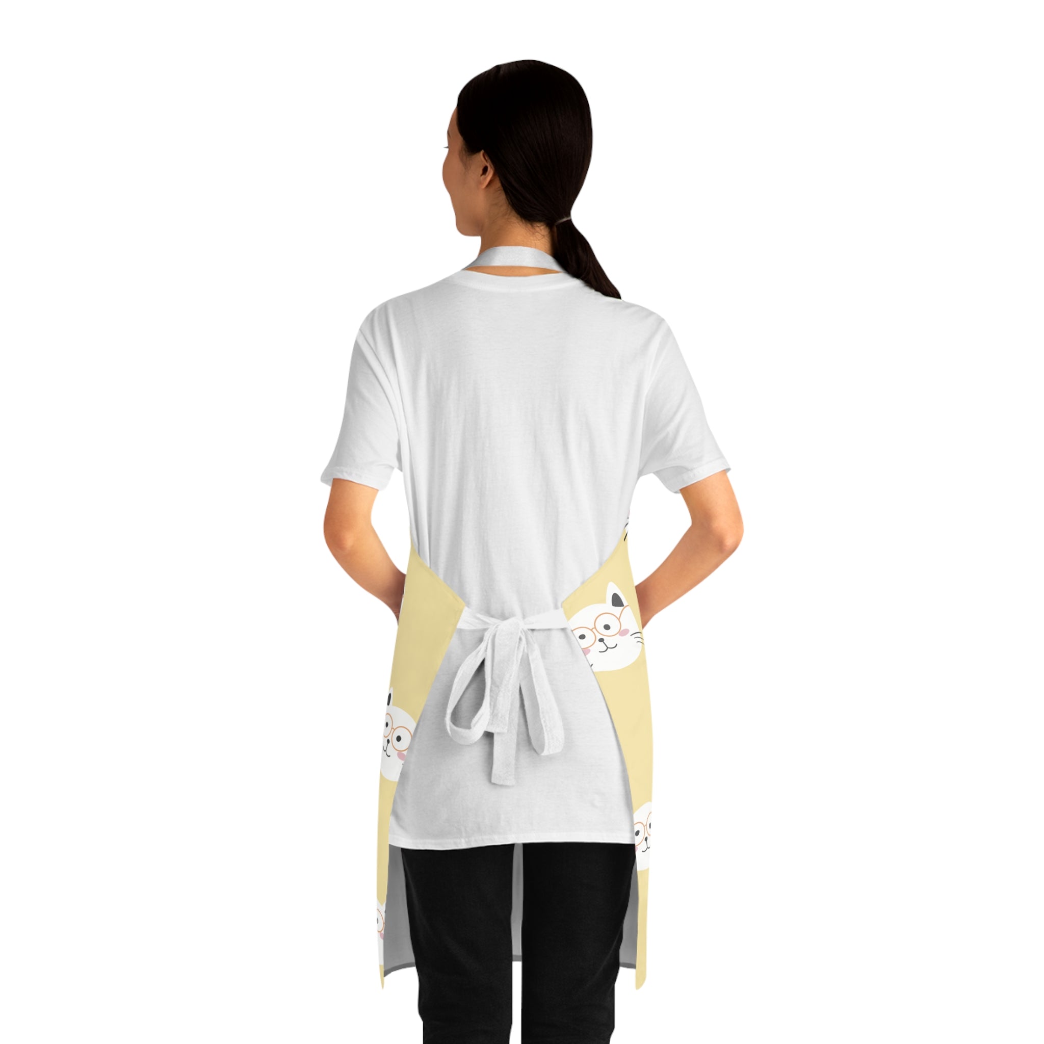 Back view of a model wearing a yellow apron with smiling cat pattern