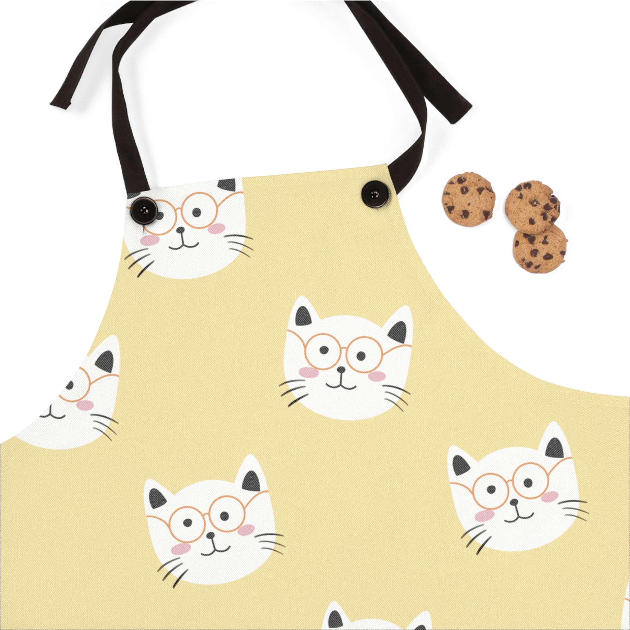 Image of the yellow Chef Happy Cat apron with a graphic of a smiling, white cat's head wearing glasses.