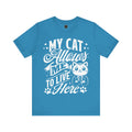 A blue crew neck t-shirt with the text 'MY CAT ALLOWED ME TO LIVE HERE' and an illustration of a cat.