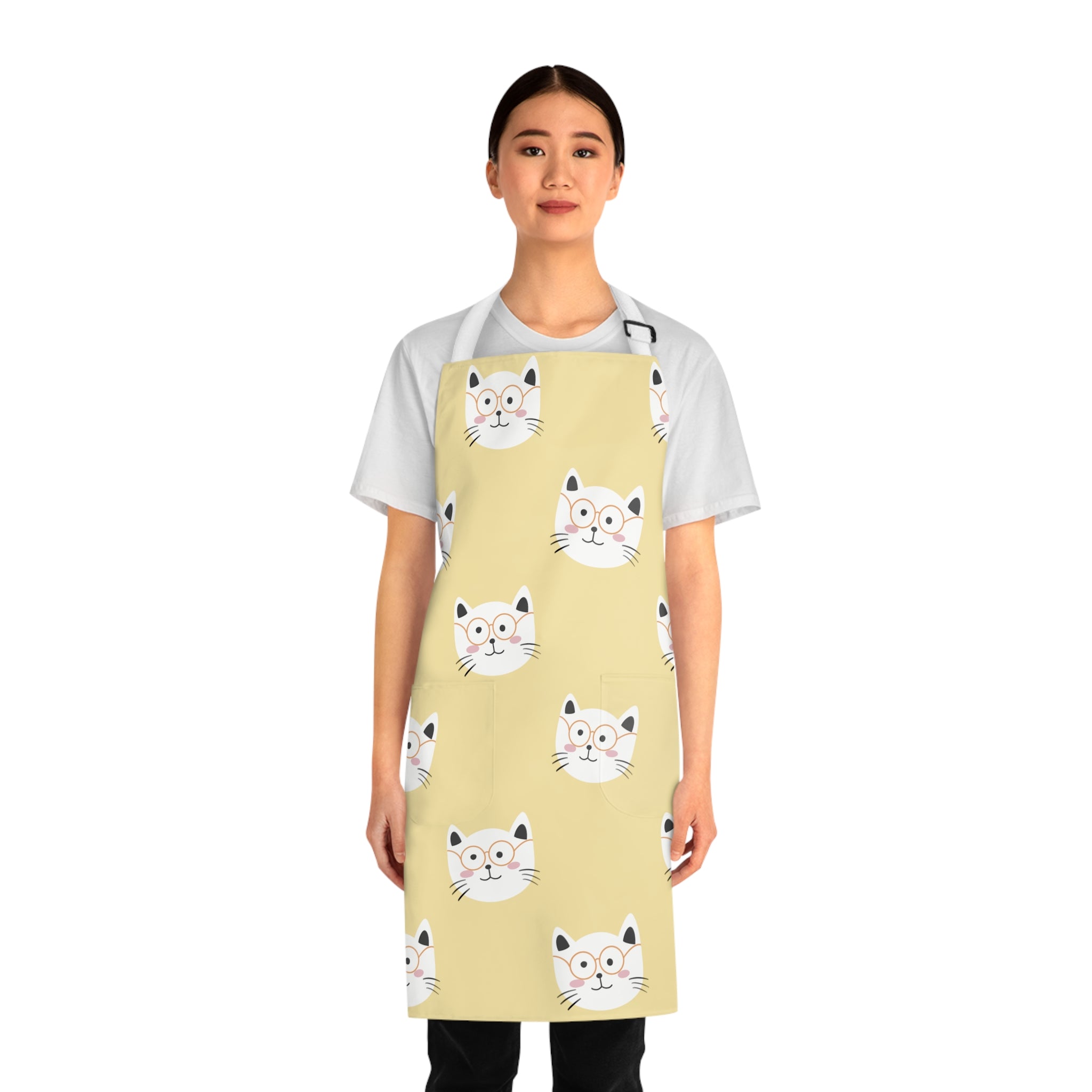 Model wearing a yellow apron with smiling cat pattern 